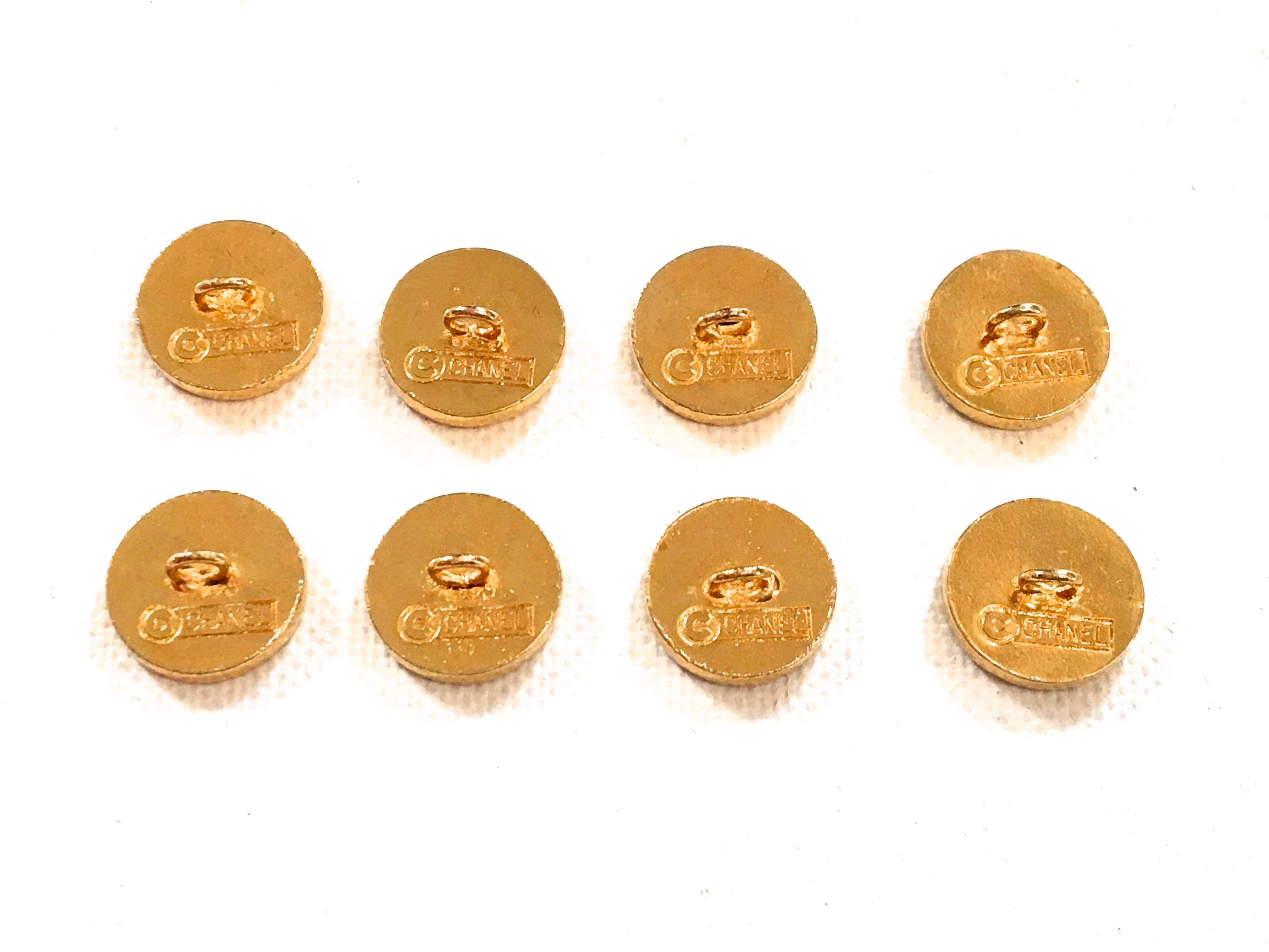 Presented here are 8 magnificent Chanel buttons. These gold tone buttons are extremely rare to find, especially in a matching set of 8. The front of the button has an elephant logo and on top reads, 'Chanel Paris.' Beneath the elephant it says