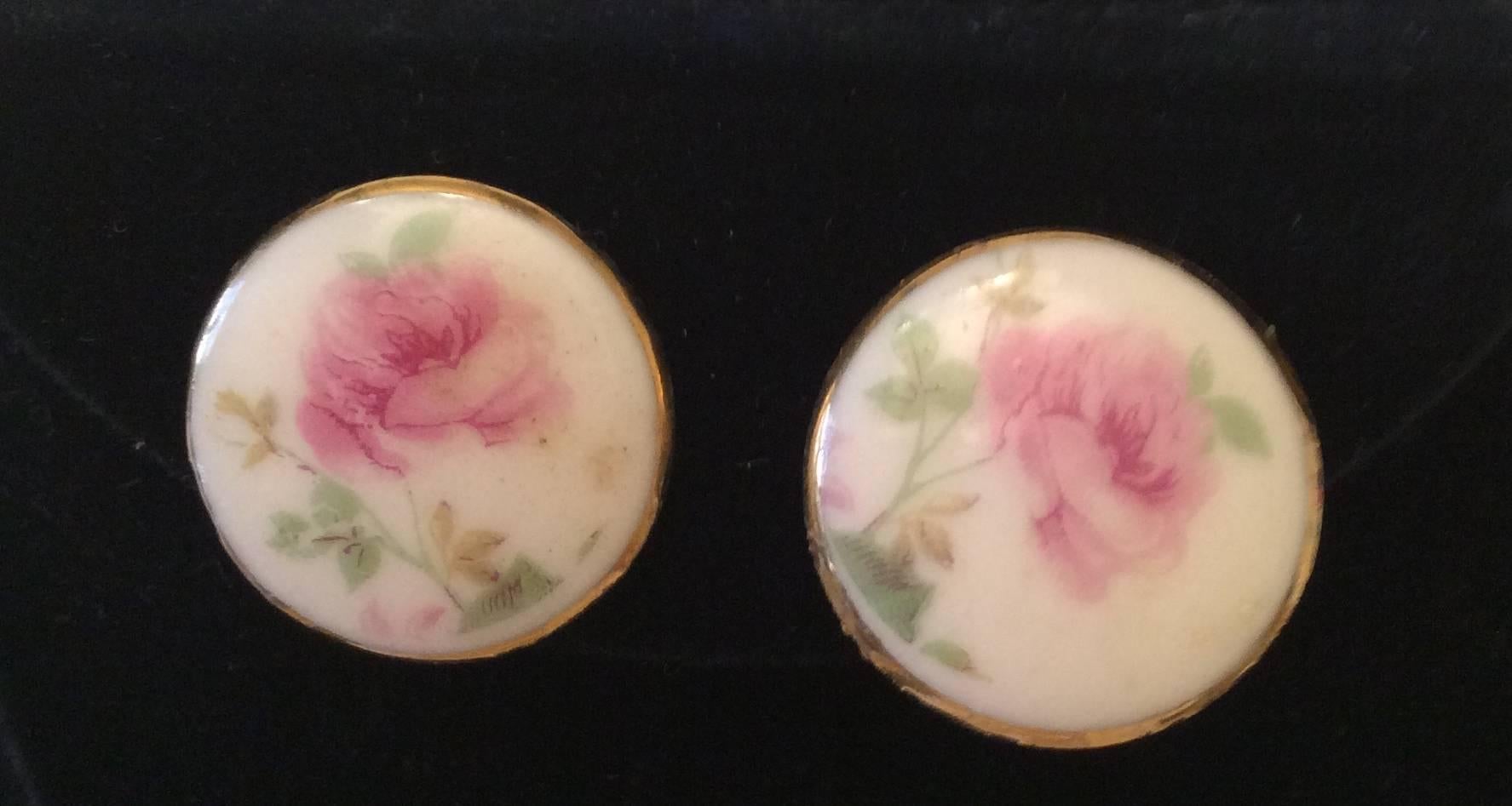 Presented here is a beautiful brooch and earring set from the 1920's. The set is all made out of porcelain and set in gold tone metal backings. The images painted onto the porcelain are that of beautiful pink roses on each piece. The brooch has a