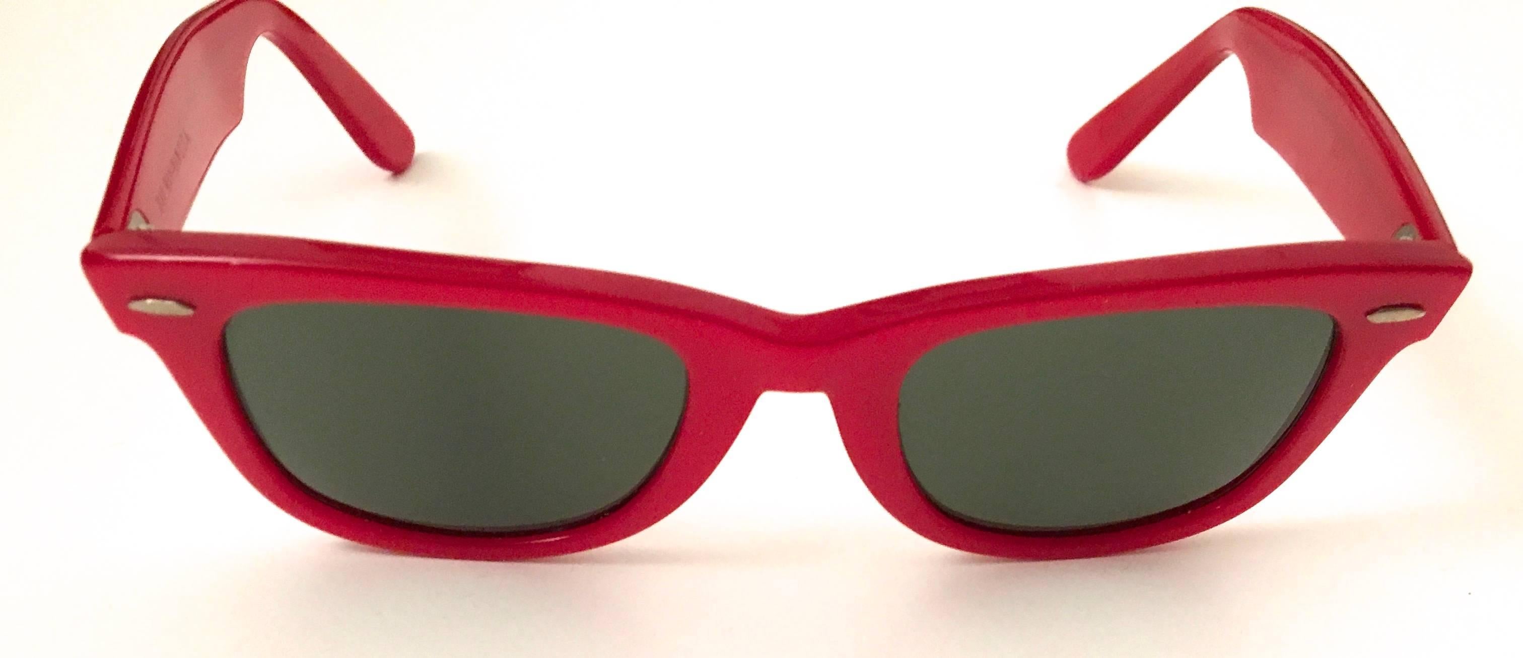 Presented here is a pair of Ray Ban sunglasses. This pair was originally purchased in the 1980's and is in mint condition. An iconic model of glasses that is historic in the fashion world. The color is a pearlescent red and is absolutely