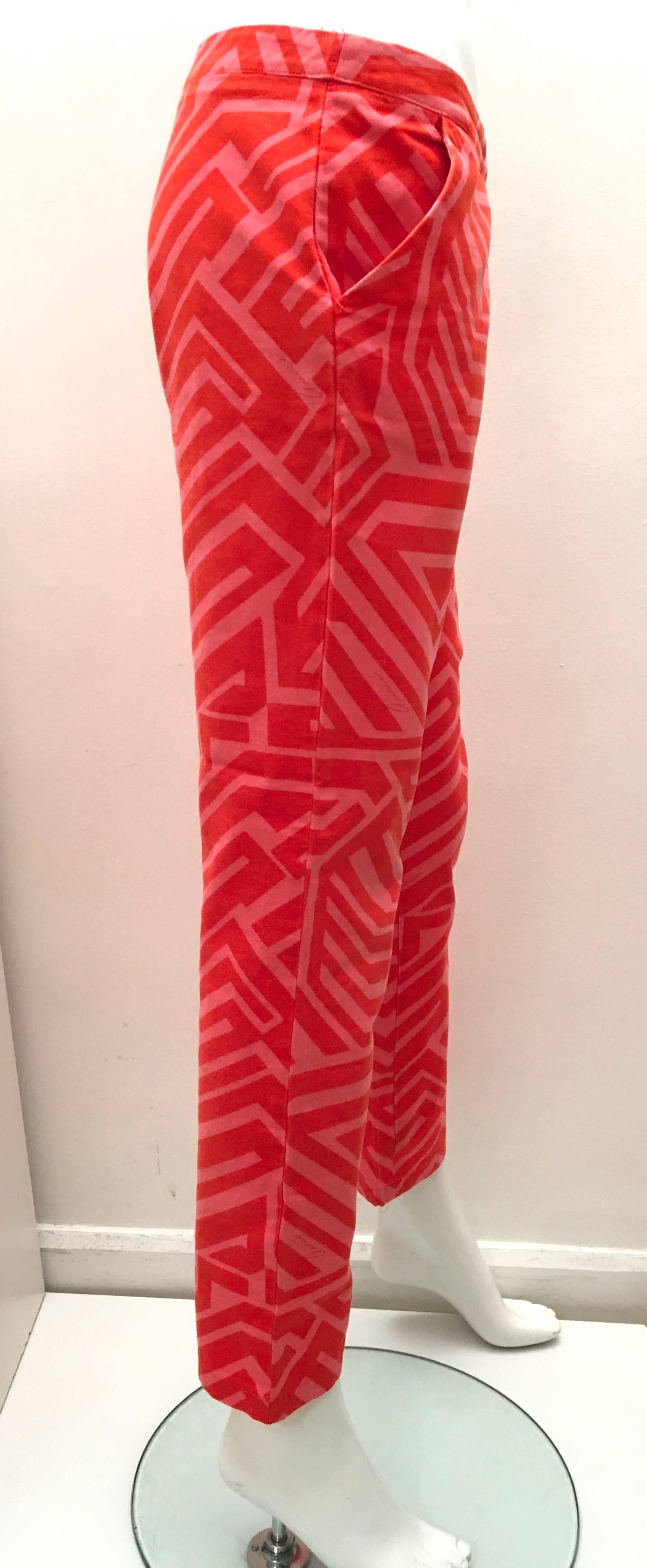 Presented here is a beautiful pair of Gucci pants. The pants are from the 1980's and are made from 100% cotton. The design of the pants consists of a pattern of dark pink geometric lines patterned against a background of solid red. The Gucci