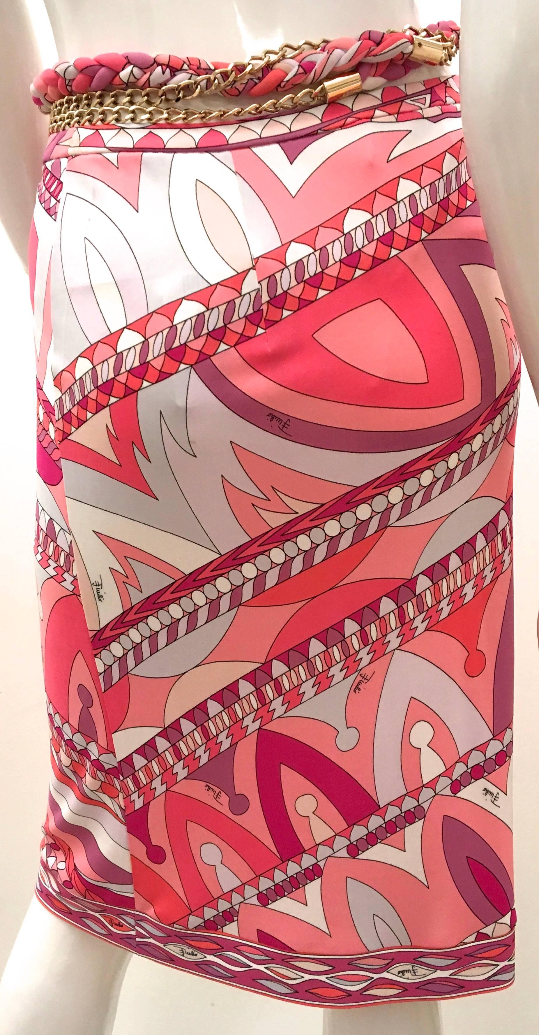 Presented here is a beautiful new Emilio Pucci skirt. The size is your typical fabulous pattern which makes Emilio Pucci so famous. Various geometric shapes in shades of fuchsia, pink, orange, and white. The skirt is a USA size 12, a UK size 14, a