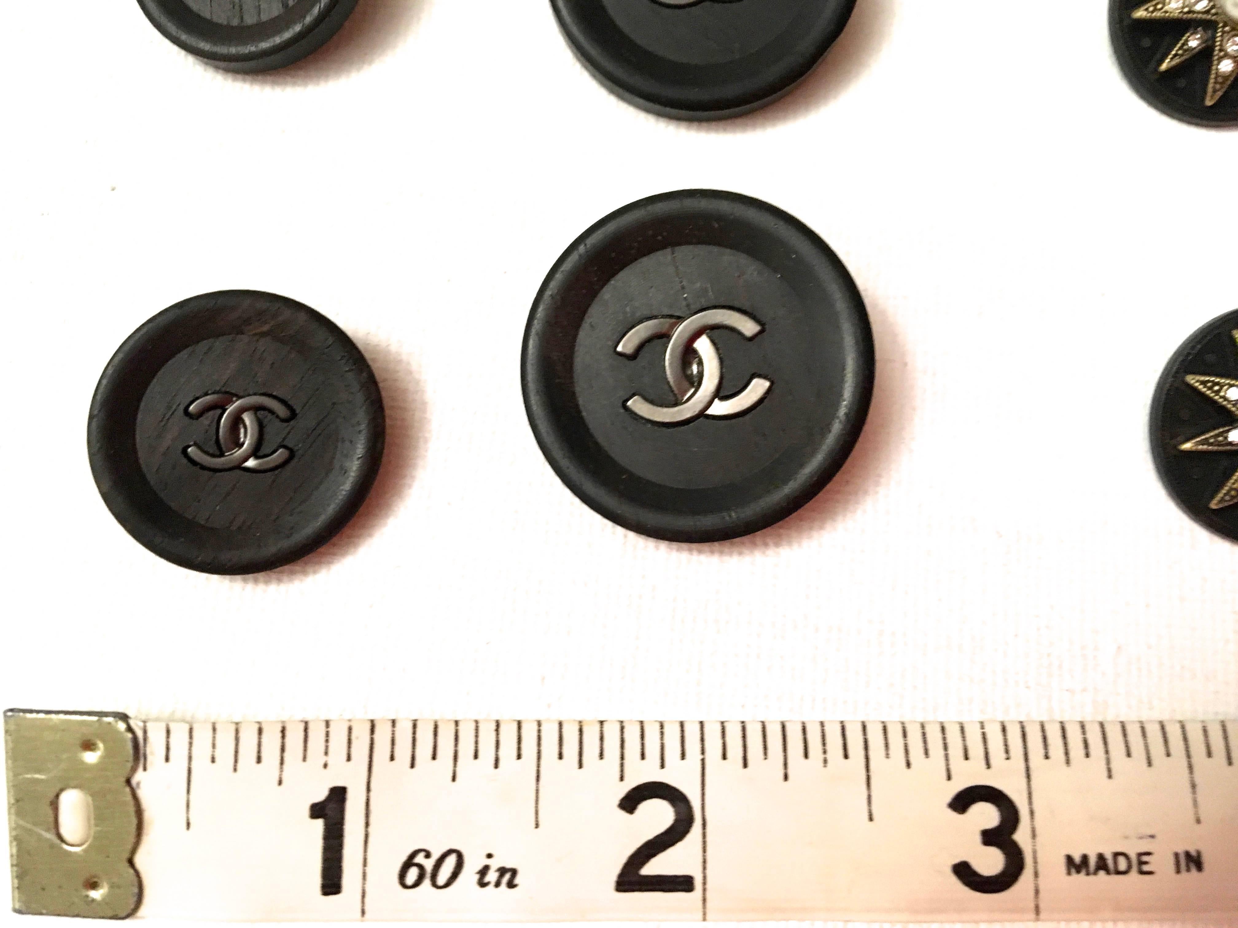 Presented here is a beautiful set of buttons from Chanel. In this particular lot, there are 4 buttons that are dark brown almost black, and there are 4 buttons that are a series of starbursts at the center of the front. Each starburst button has a