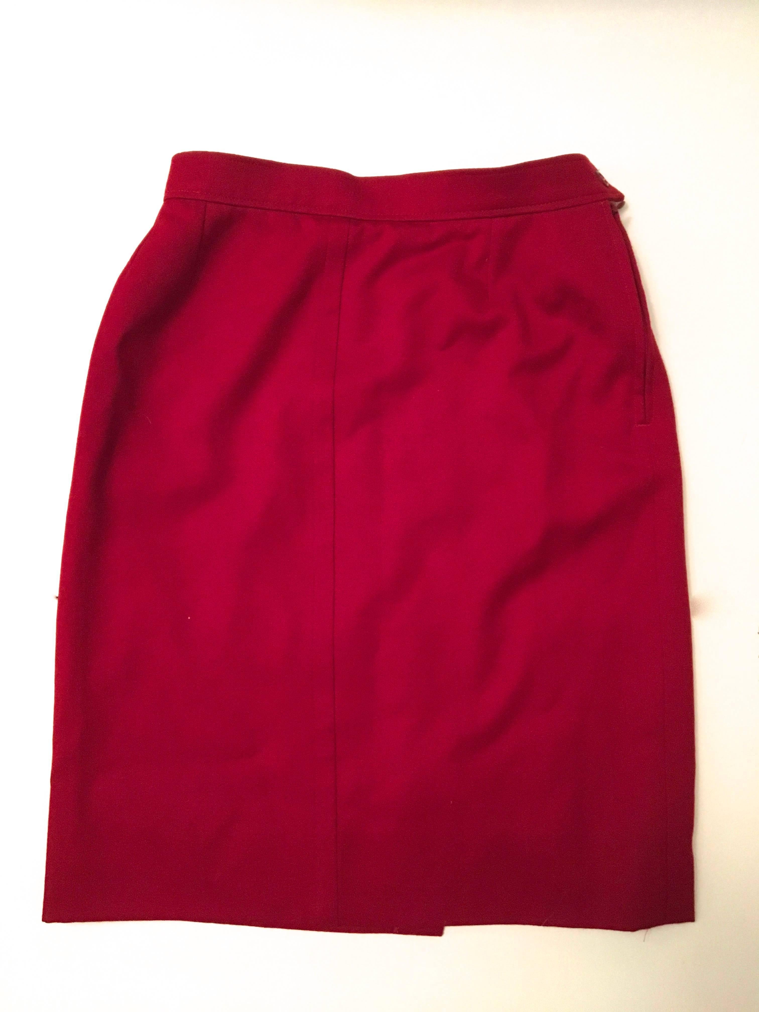 Presented here is an Yves Saint Laurent variation. It is a red wool skirt. It is a timeless skirt which is a must for any wardrobe. The skirt is 100% wool. Made in France. It is listed as a size 4. It is a straight red wool skirt with a 1.5 inch