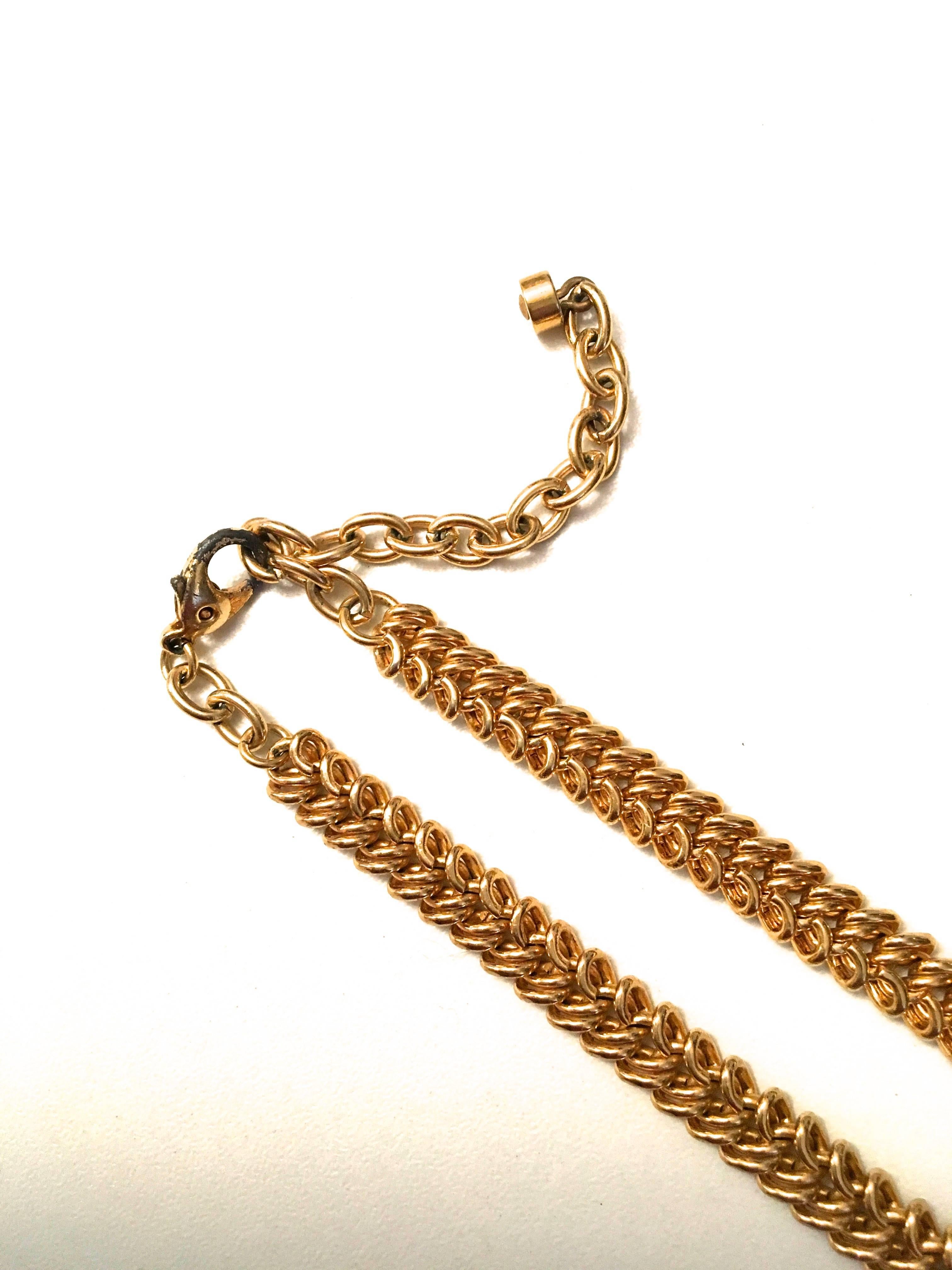 Presented here is a beautiful vintage necklace from Balenciaga. The necklace is comprised of a beautifully crafted gold tone metal chain. The sturdy chain holds a stunningly beautiful pendant at the front of the necklace. The pendant is an octagonal