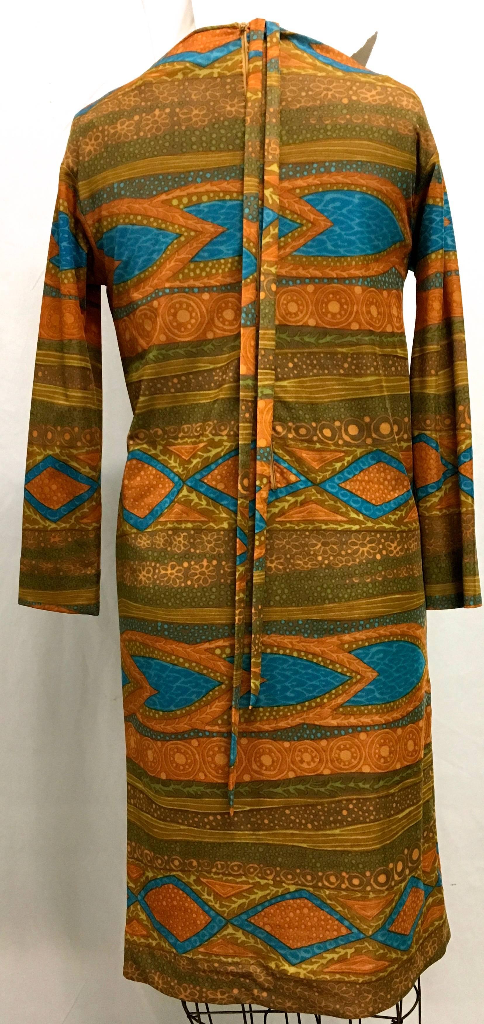 Presented here is a beautiful dress from Goldworm. This vintage dress is from the 1960's and is in near perfect condition. The dress is a design comprised of colors of blue, gold, orange, green and brown in varying shades throughout. The dress has a