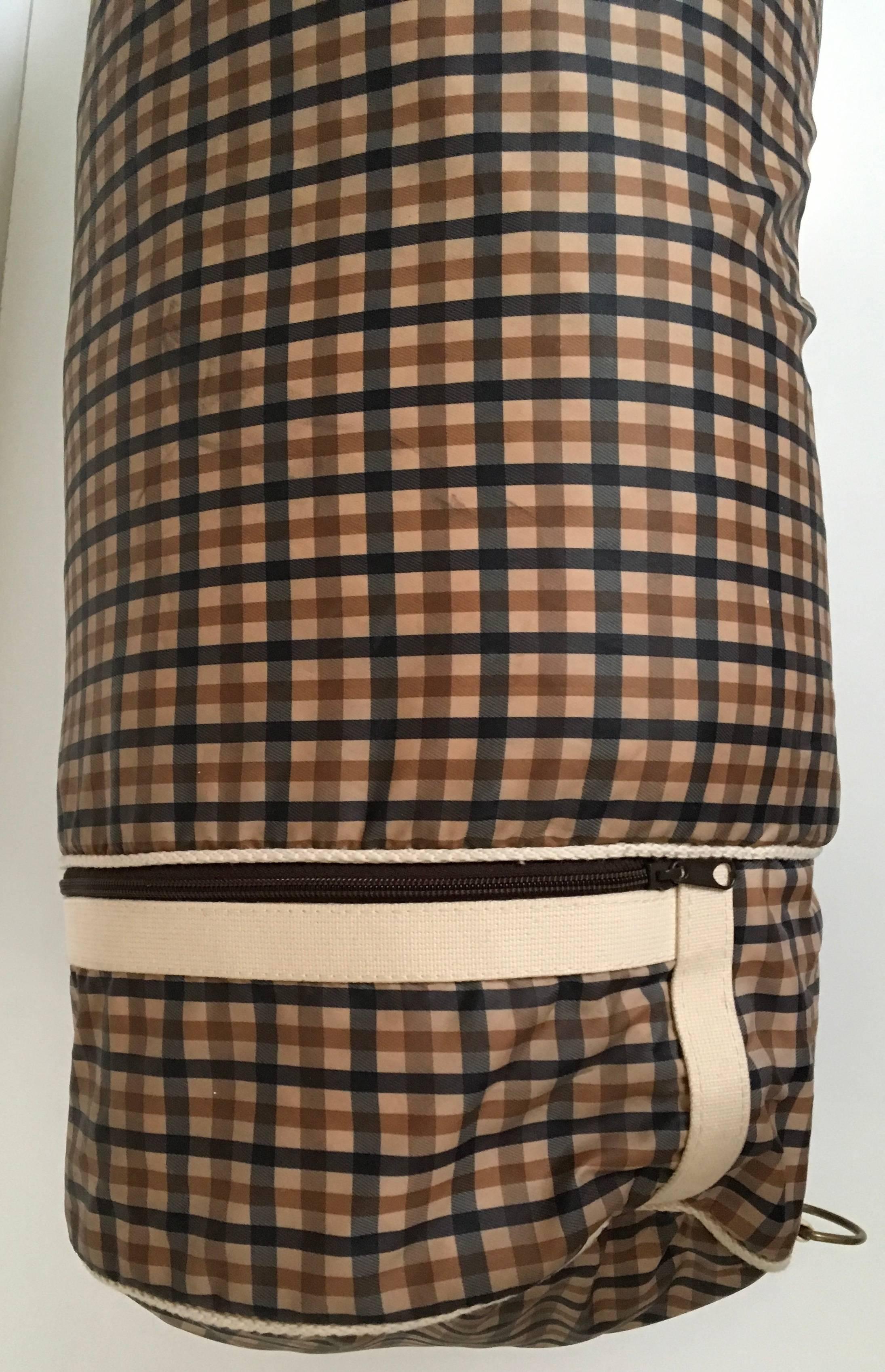 Presented here is a mint condition nylon Aquascutum duffle bag. It is an absolutely fabulous bag because it is very light. It has an adjustable cream colored canvas 1.5 inch strap. There is a rope tightening strap at the top with a 1.5 inch piece of