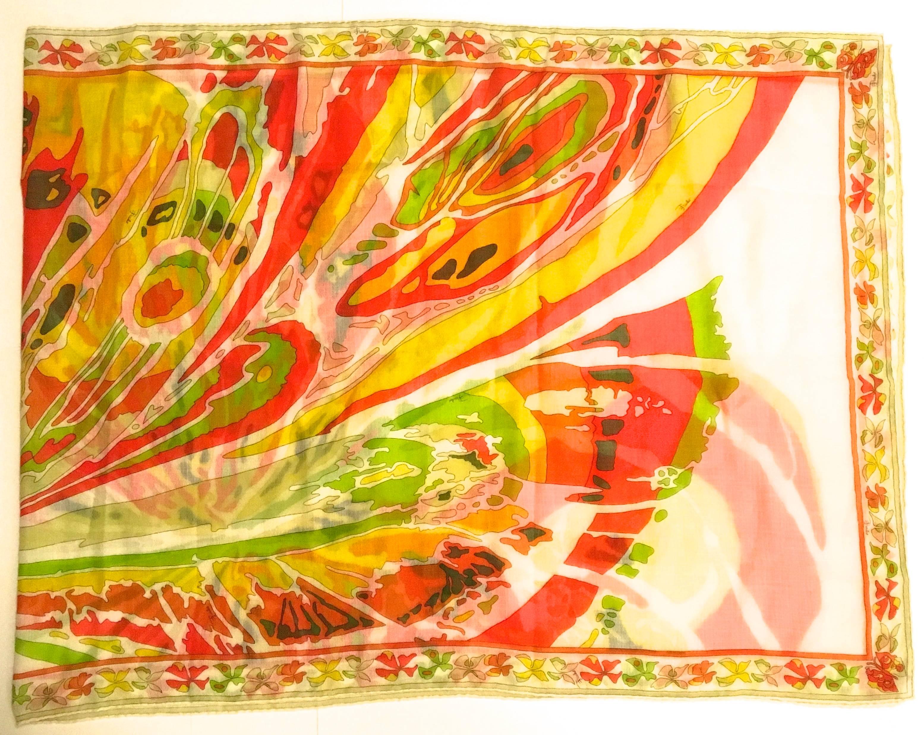 Presented here is a magnificent shawl / scarf from Emilio Pucci. This rare scarf is comprised of a beautiful floral print in colors of green, yellow, white, blue, red and black. The design is a singular flower that appears to have an expansion of