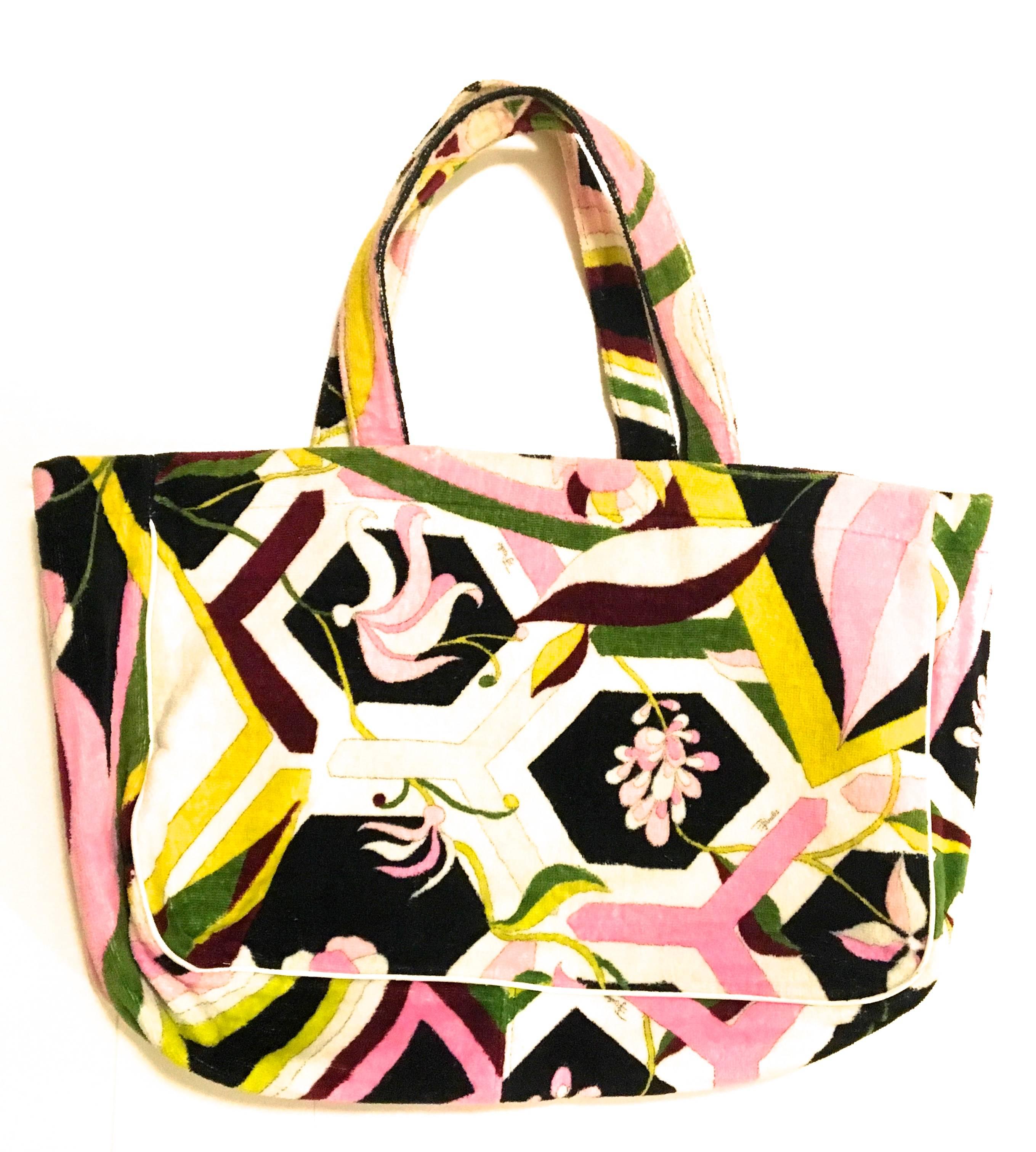 Presented here is a tote bag from Emilio Pucci. This beautiful tote bag is made from soft 100% cotton terry cloth on the exterior of the bag. The interior of the bag is entirely lined in soft creamy white leather. The bag is a great tote bag that