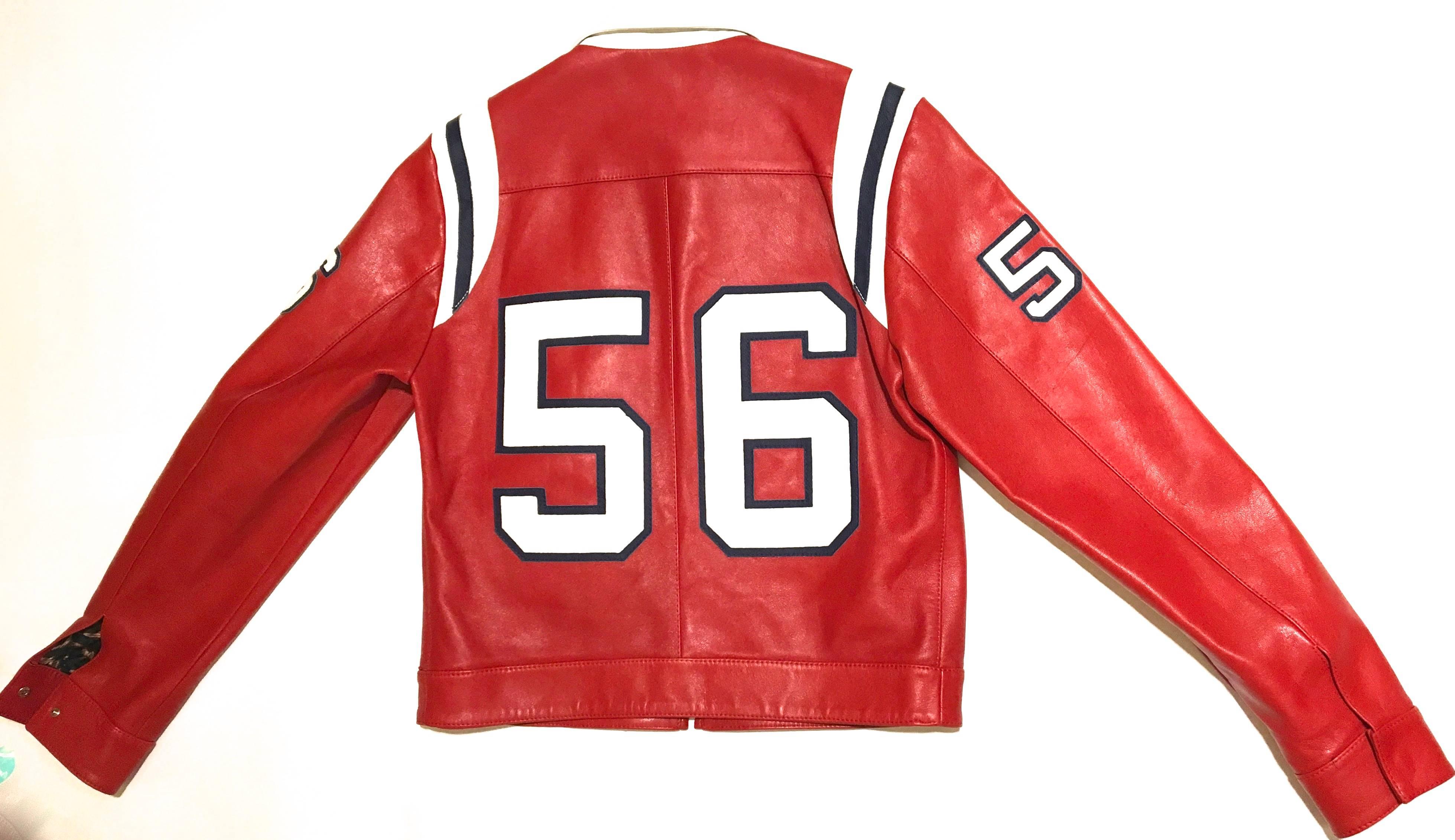 Presented here is a beautiful jacket from Dolce and Gabbana. This extremely rare and unique men's jacket is comprised of a very high quality soft grain of leather throughout the jacket. The jacket is a rich red with white numbers on the front, back