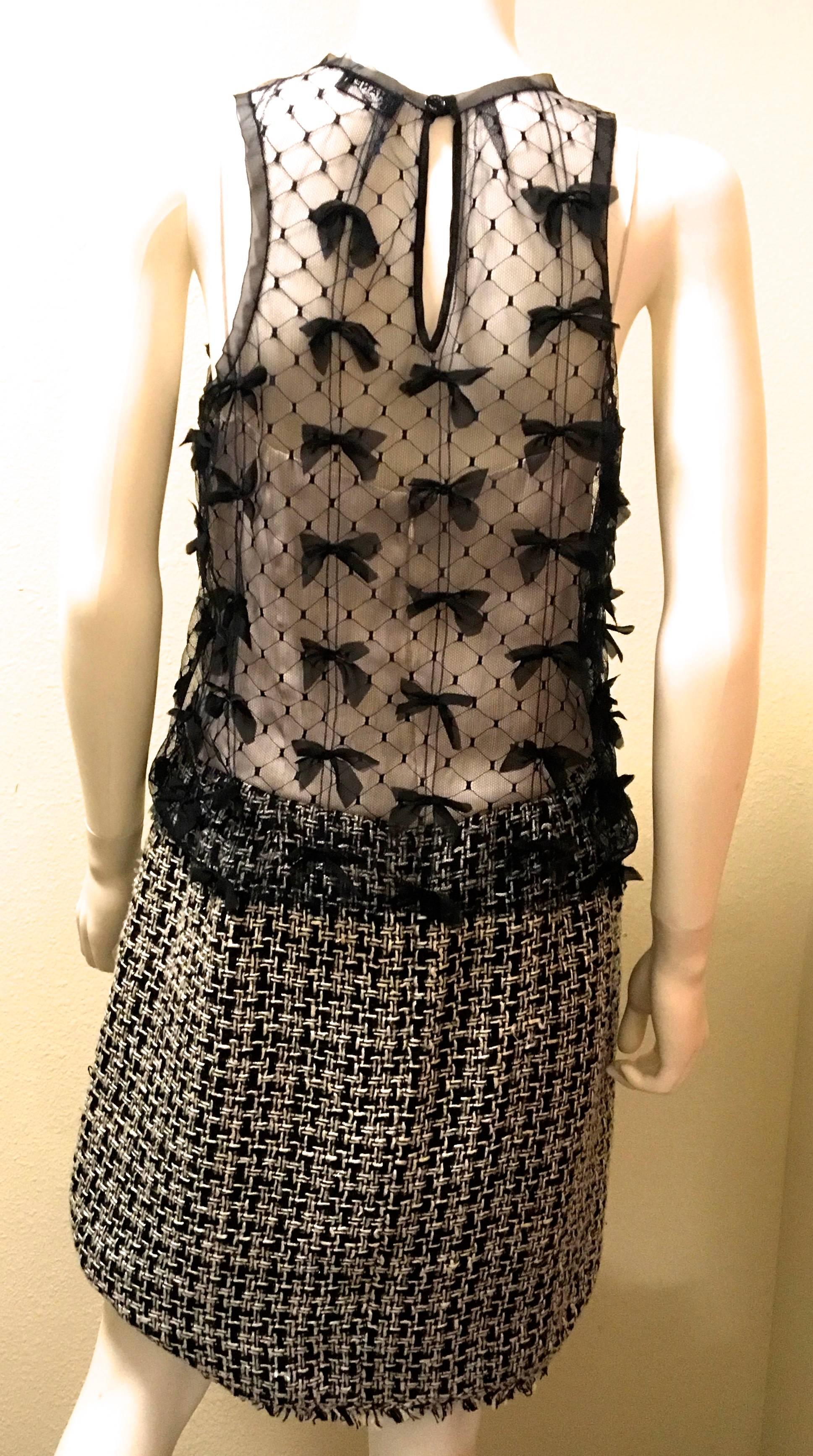 Presented here is a fabulous dress from Chanel. This fabulous dress is comprised of two layers: the underlying dress and the sheer nylon overlay that is worn outside the other dress. The underlying dress is made of 100% silk from the waist up. From