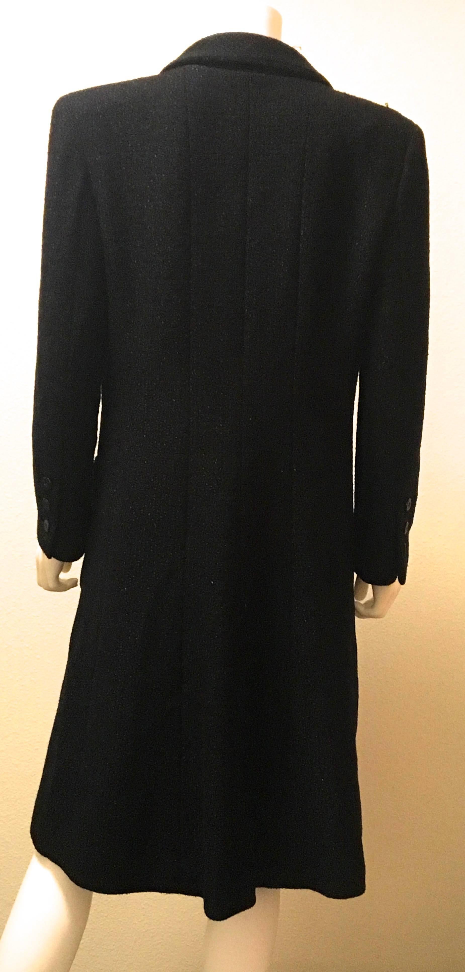 Presented here is a classic, timeless black Chanel coat with matching skirt. The double breasted coat is listed as a size 42, but please pay careful attention to the sizing. There may have been some alterations.  There are 8 beautiful buttons going
