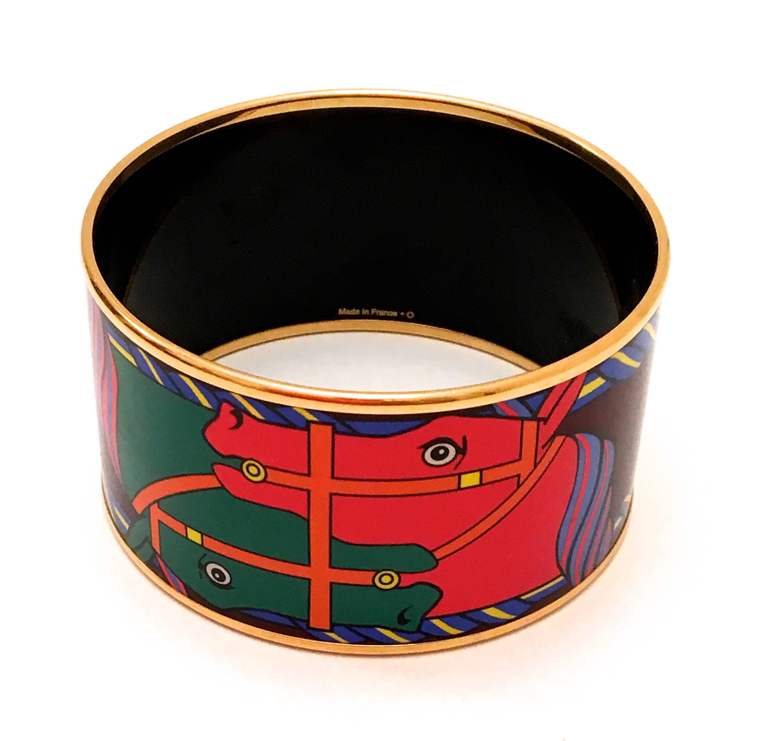 Presented here is a beautiful enamel bracelet from Hermes Paris. This bracelet is comprised of a equestrian horse print in colors of red, purple, blue, yellow, orange and green. The size is 'Extra Wide.' On the interior the words 'The Big Bangle' is
