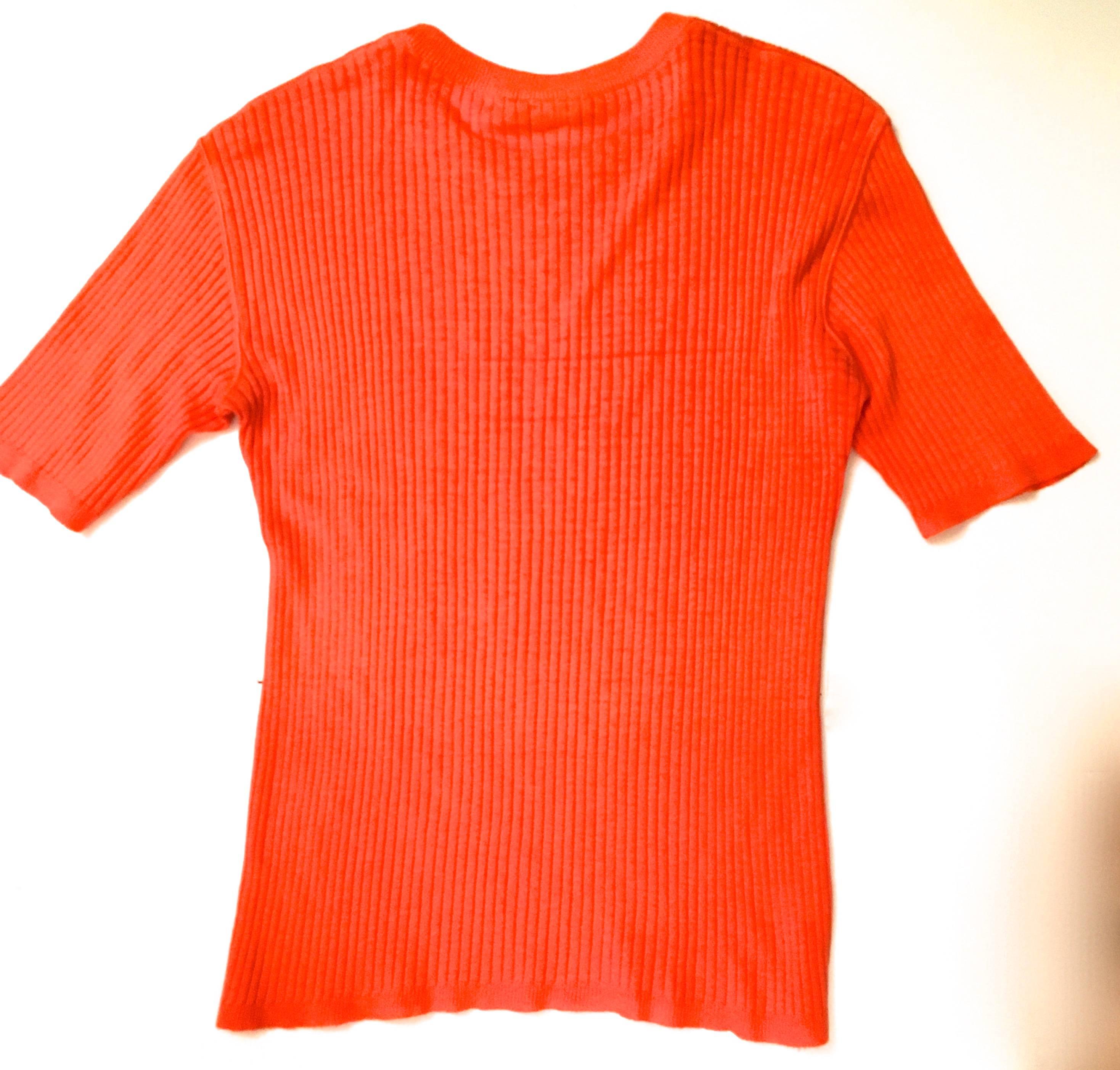 Presented here is an vintage men's sweater from Courreges. This extremely rare vintage sweater is from the 1960's and is in excellent condition. The sweater is orange and has the Courreges insignia embroidered on the chest of the sweater. The