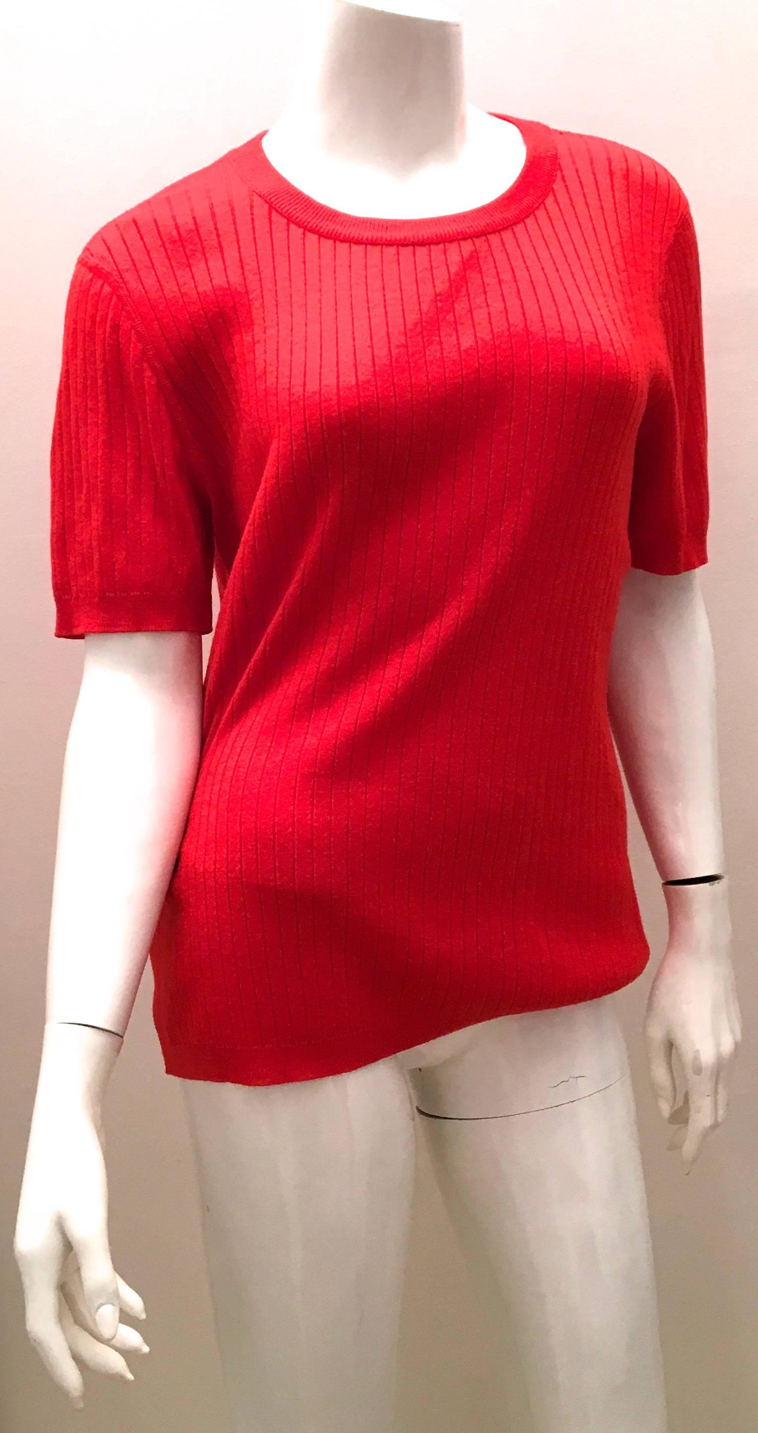 Presented here is a Courreges red cardigan sweater with matching short sleeve sweater. It is from the late 1960's / early 1970's. The cardigan is a v-neck cut and buttons down the front. It is from My guess is it would fit about a size 8 - 12. The