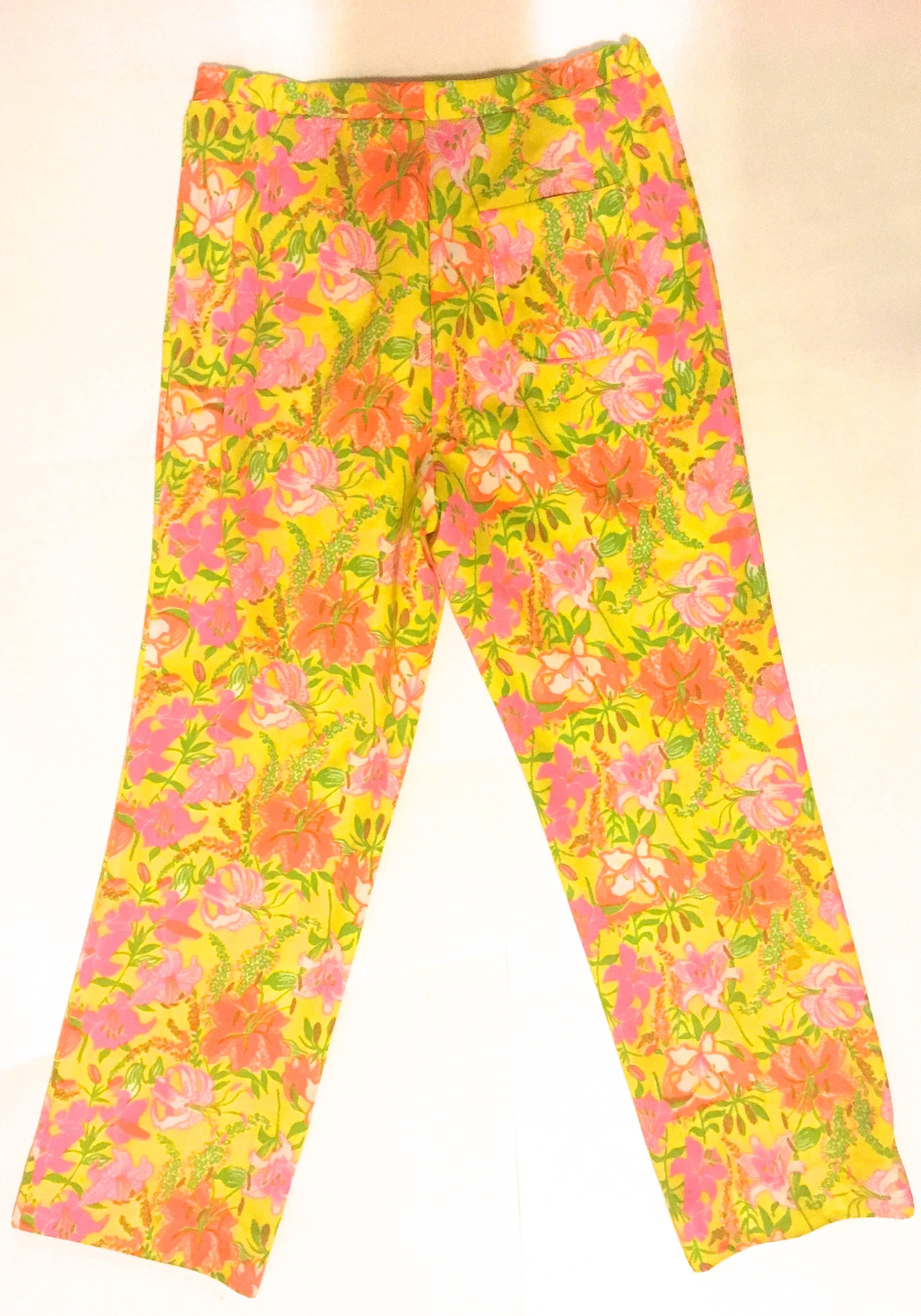 Presented here is a gorgeous pair of Lilly Pulitzer pull-up pants from the late 1960's. This extremely rare pair of pants is comprised of a floral print of shades of yellow, orange, green, white and pink. There is a bit of stretch to the waist of