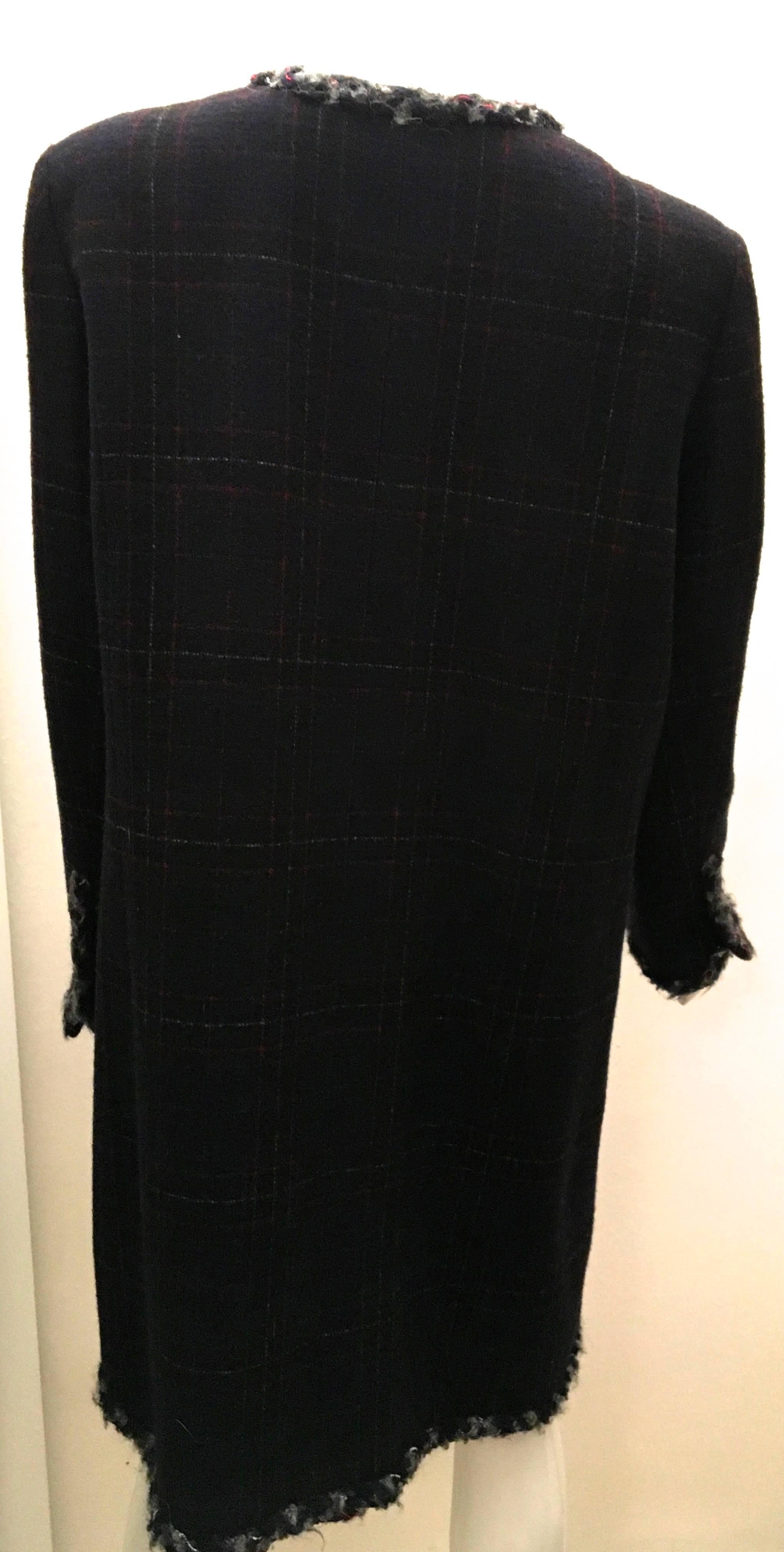 Presented here is a Chanel boucle coat that screams Chanel in that ever so subtle way.  The coat is a size 46 although no alterations have been made it seems to run a bit small. But, as always with Chanel there is plenty of room for adjustments to