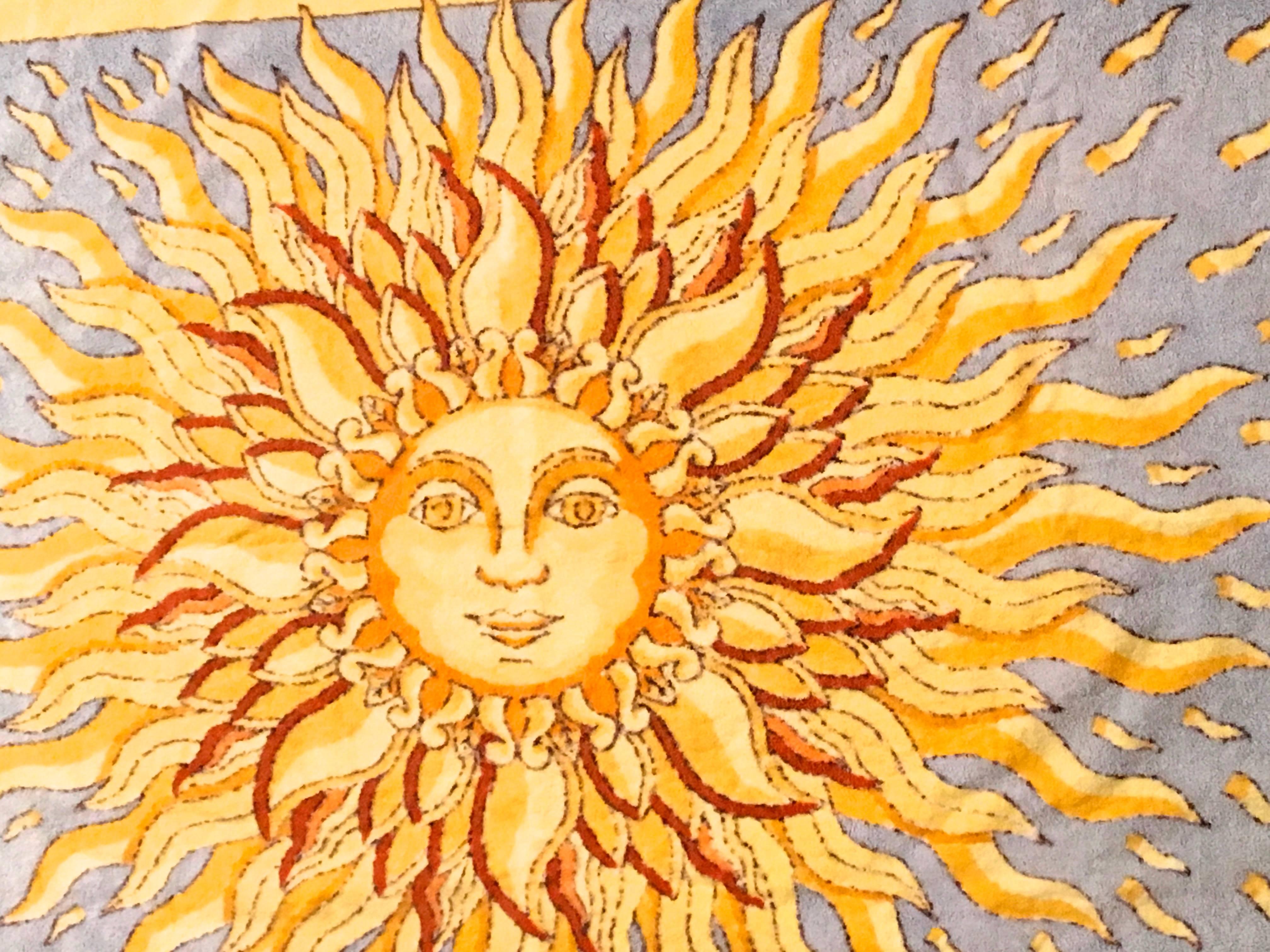 Presented here is a lovely beach towel by Hermes Paris. This beautiful beach towel is made from 100% cotton. The design is a large sun with a face in vibrant colors of orange and yellow. The design of this towel is timeless. The towel is signed