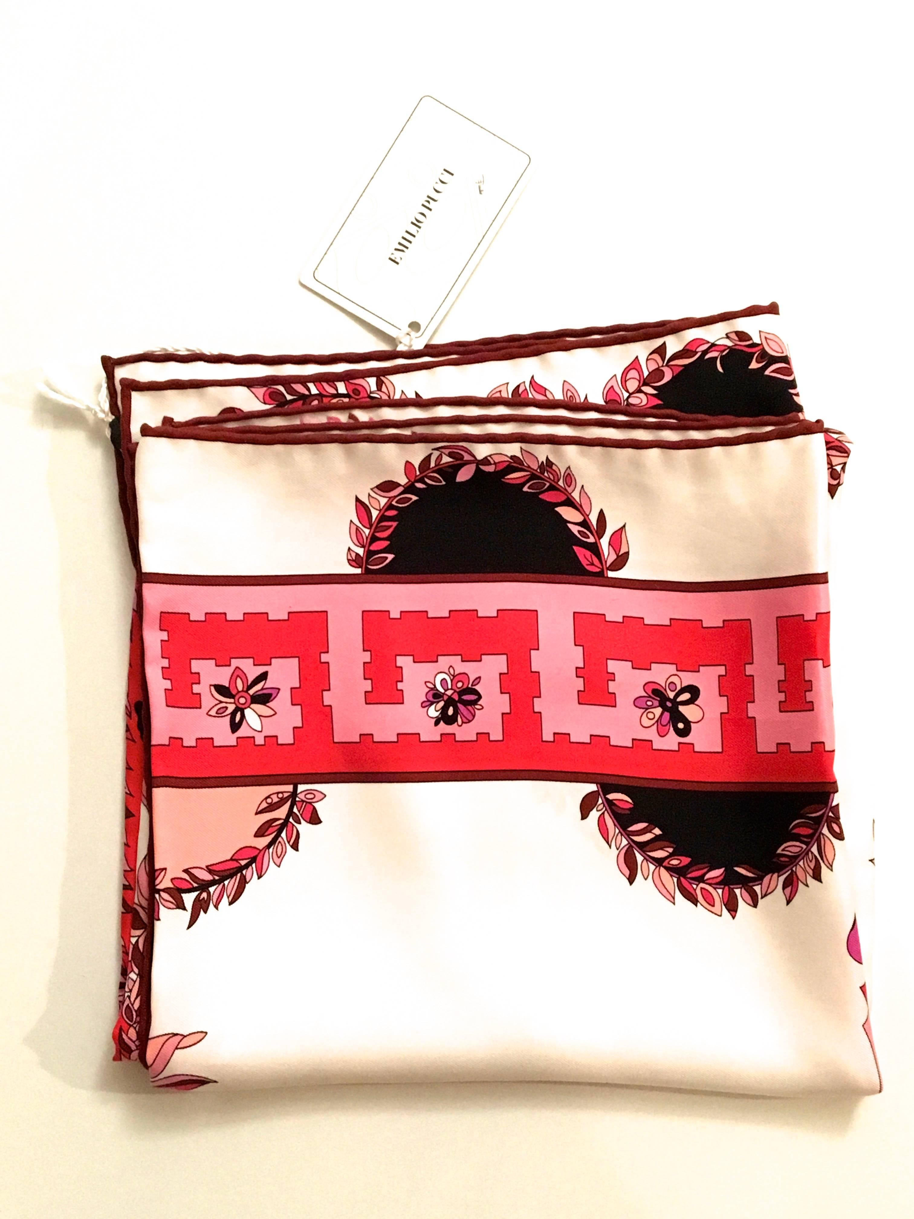 Presented here is a new beautiful Emilio Pucci elaborate silk print scarf. The scarf is square and is comprised of a design that is shades of magenta, red, white, purple, black and pink. As with all Emilio Pucci designs, this scarf is absolutely