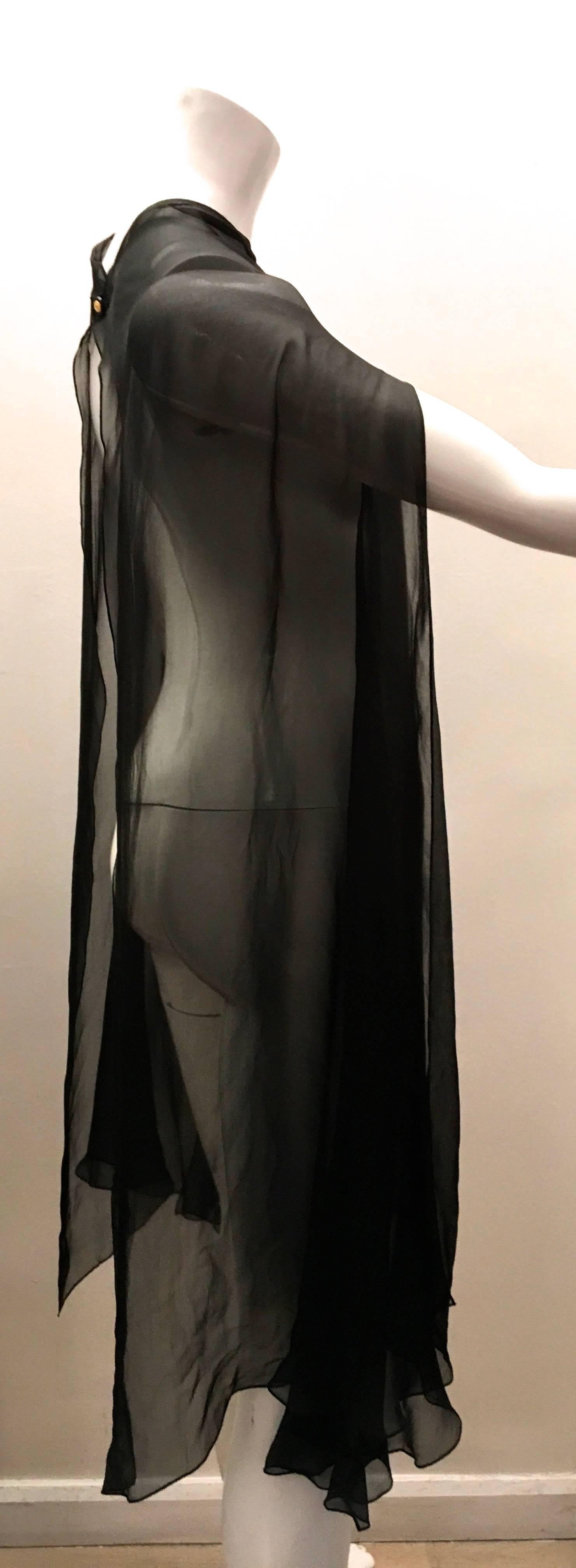 Presented here is a magnificent sheer cape from Chanel. This gorgeous cape is made from a fine 100% silk that feels absolutely magnificent. The cape can be worn as a sheer cover for a large ensemble or it can be used with a smaller garment