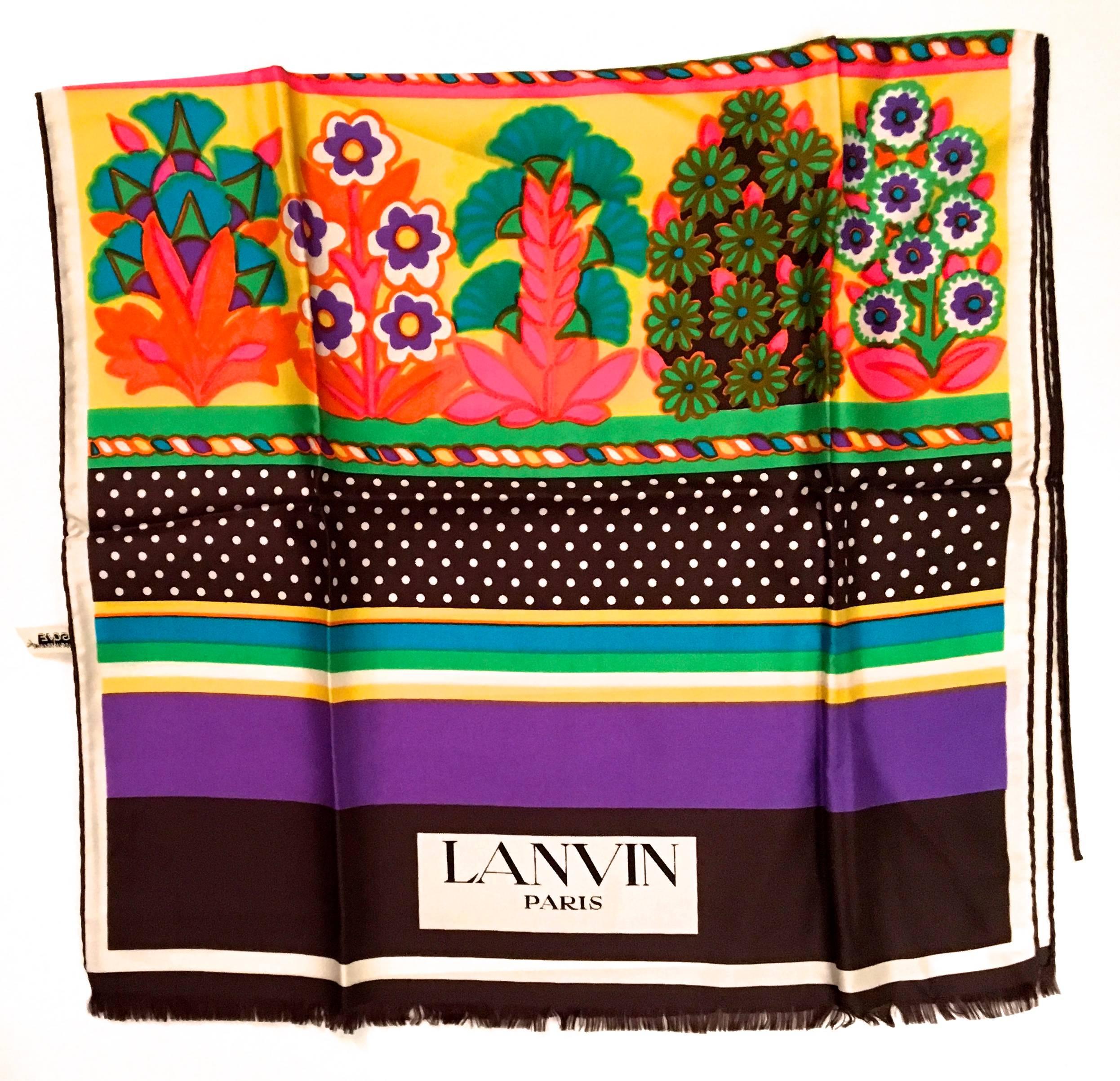 Presented here is a fabulous scarf from Lanvin Paris. This beautiful silk scarf is made from 100% silk. It is separated into different sections. Each section is a different colorful design. Every color of the rainbow is featured in the scarf’s