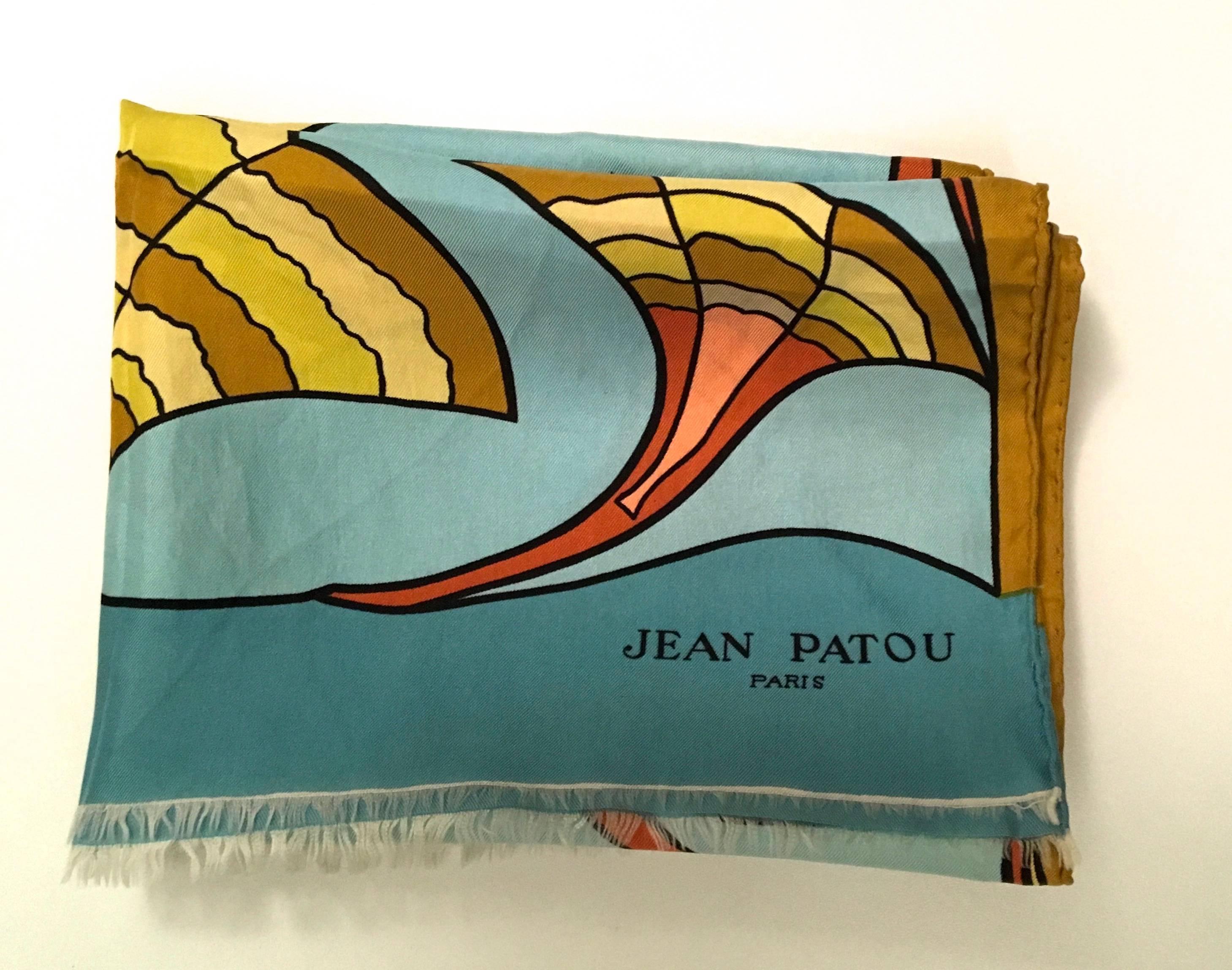 Presented here is a vintage scarf from Jean Patou. This rare scarf is from the late 1960's and is in excellent to near mint condition. The scarf design is comprised of a curved geometric pattern in shades of gold, rust, peach and blue. 

The scarf