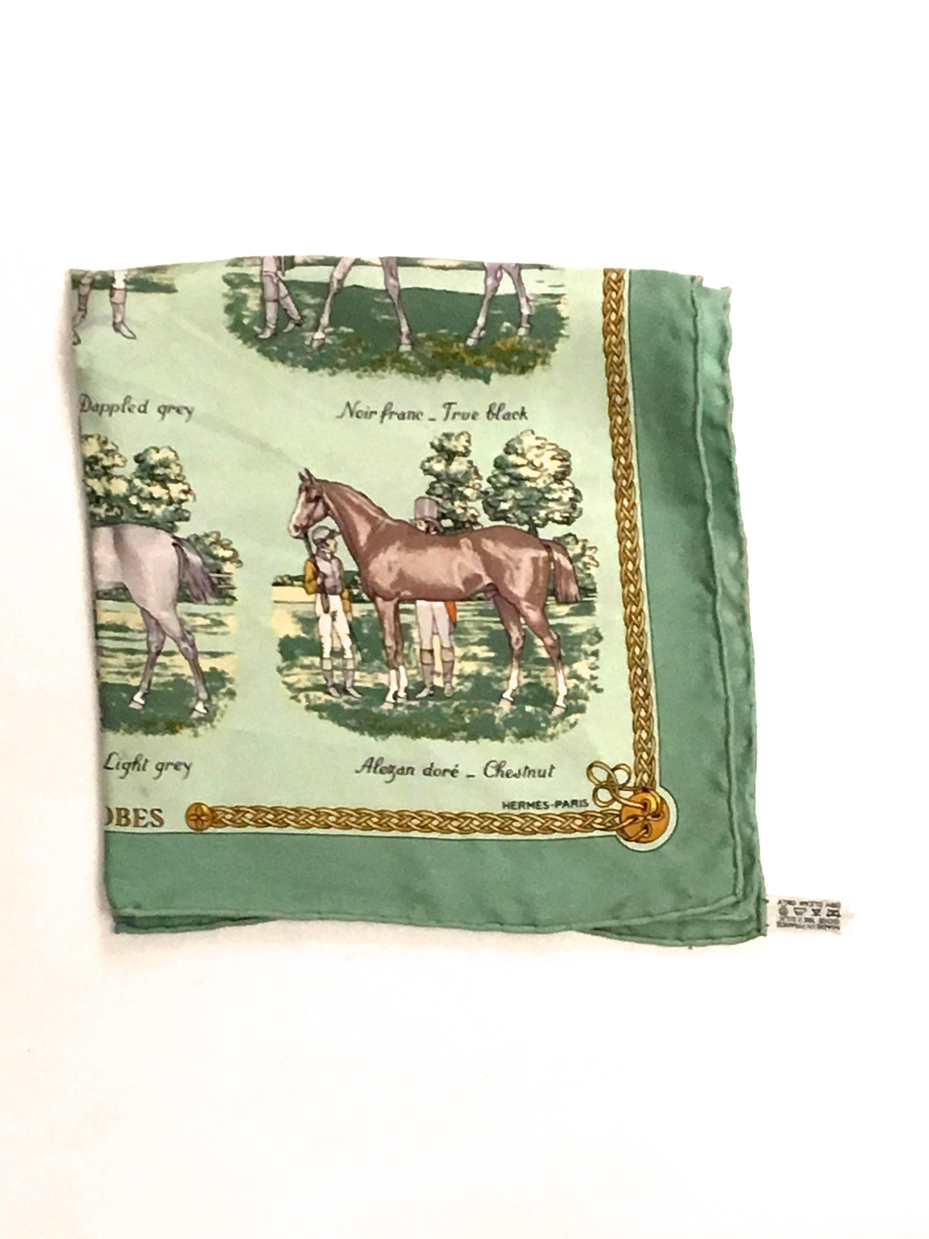 Presented here is a beautiful scarf from Hermes Paris. This vintage scarf is an equestrian theme. The scarf features a series of horses with its associated name / coloring written below the image. The drawings are laid against a background of sea