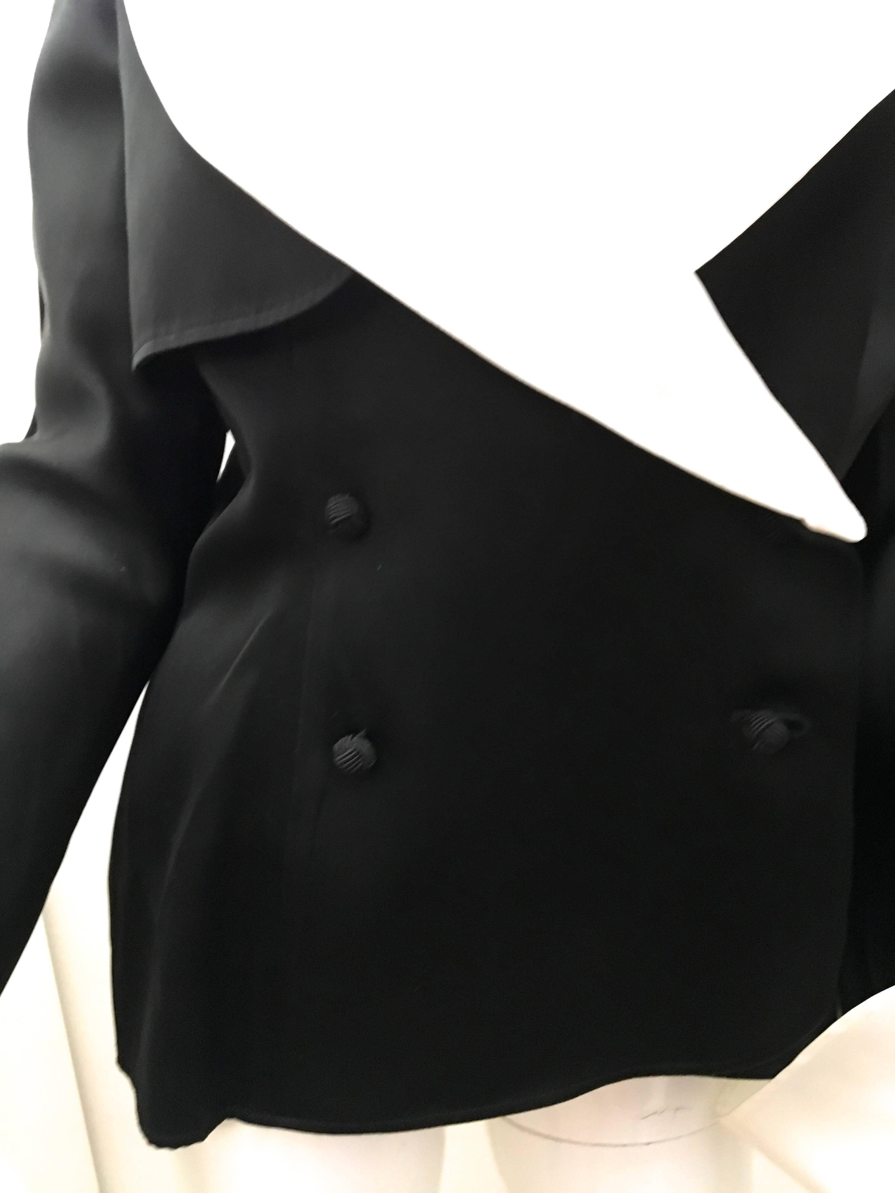 Presented here is a fabulous dinner jacket from Jean Louis Scherrer. This stunning jacket is comprised of an ultra soft black acetate with a removable white cuffs and collar. There is a delicate soft sheen that creates a beautiful look when the