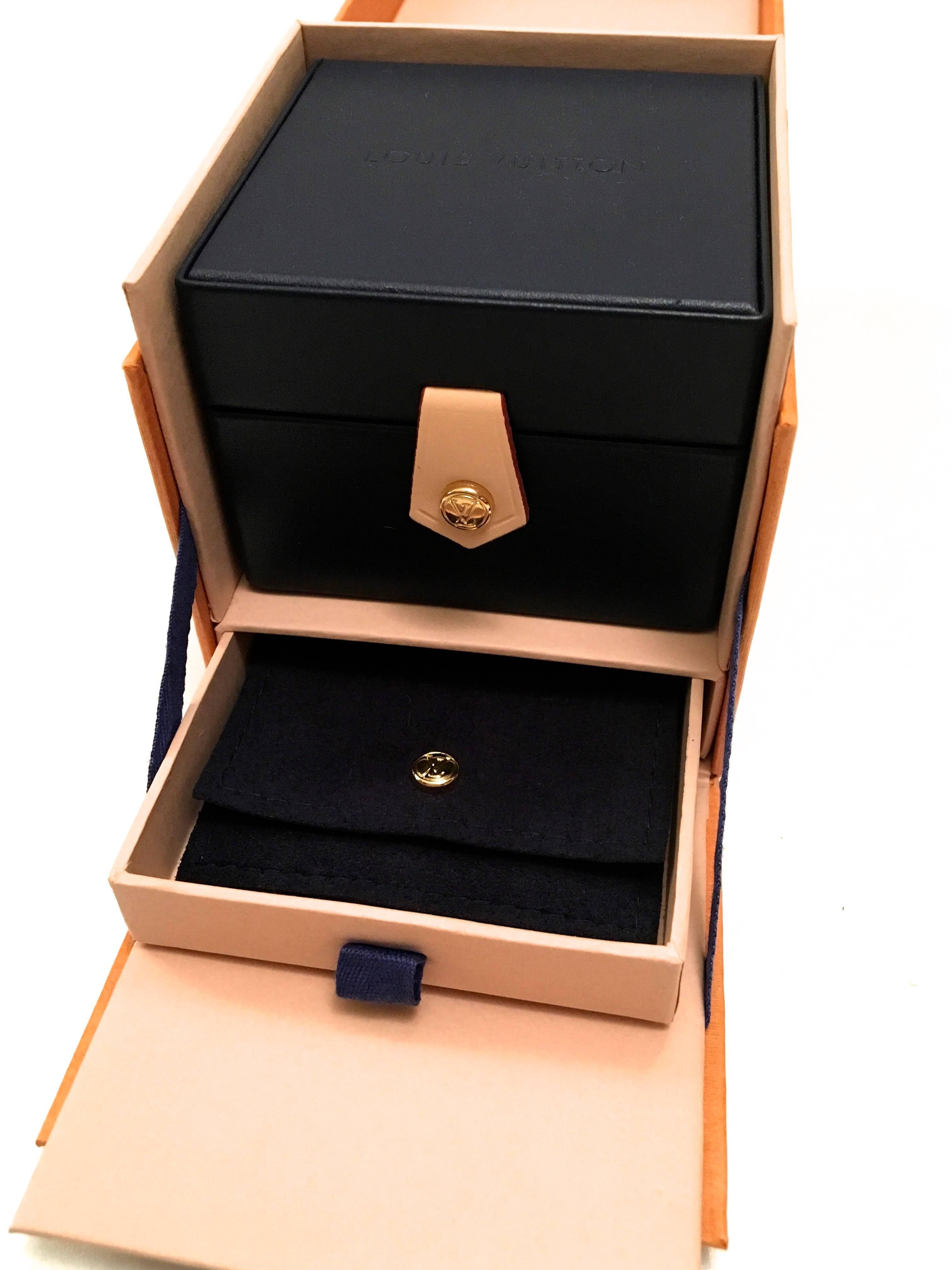 Presented here is a magnificent all leather Louis Vuitton ring box. The presentation of the box is absolutely magnificent. The beautiful dark blue leather box has a brass snap closure with LV embossed across the center on the sides of the box. When