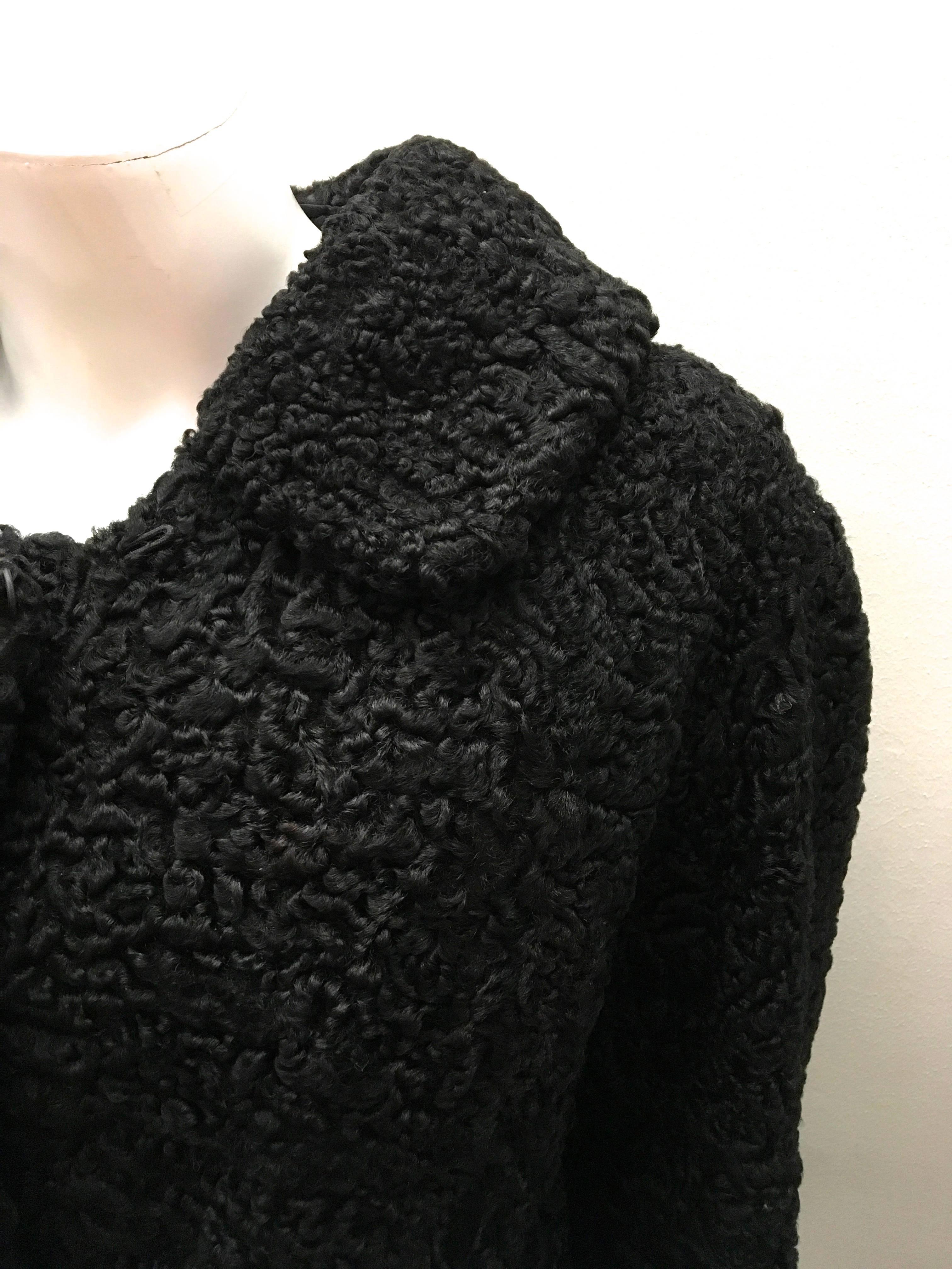 Presented here is a gorgeous persian lamb jacket. This beautiful jacket is colored black and is made entirely out of a soft Persian lamb. The unique look that Persian lamb has makes for a beautiful and timeless look. There are large buttons also