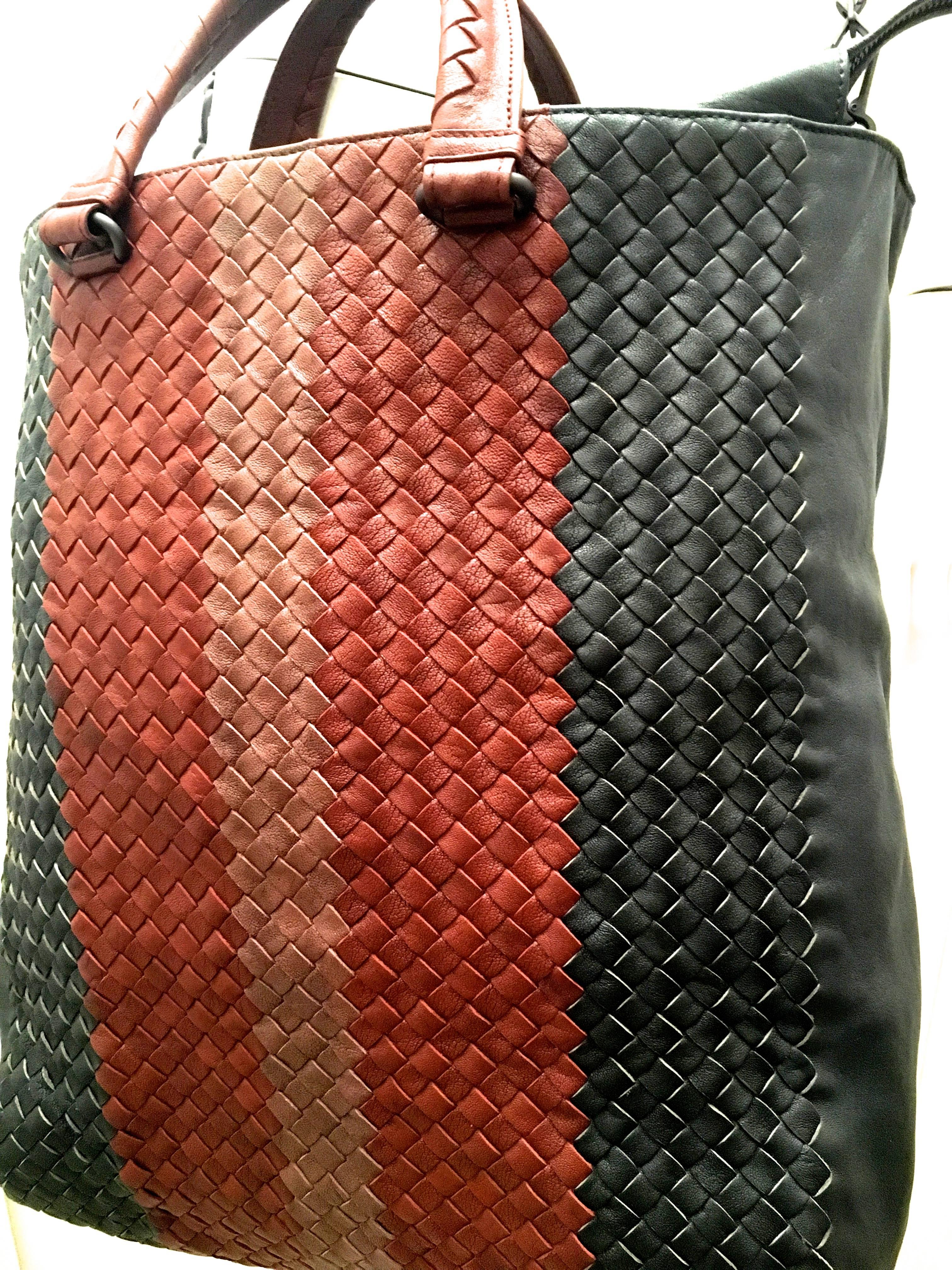 Presented here is a magnificent extra large bag from Bottega Veneta. This large sized tote can be used as a briefcase, a purse, or a crossbody bag. It consists of three colors in the marvelous woven leather Bottega Veneta is known for. The outside