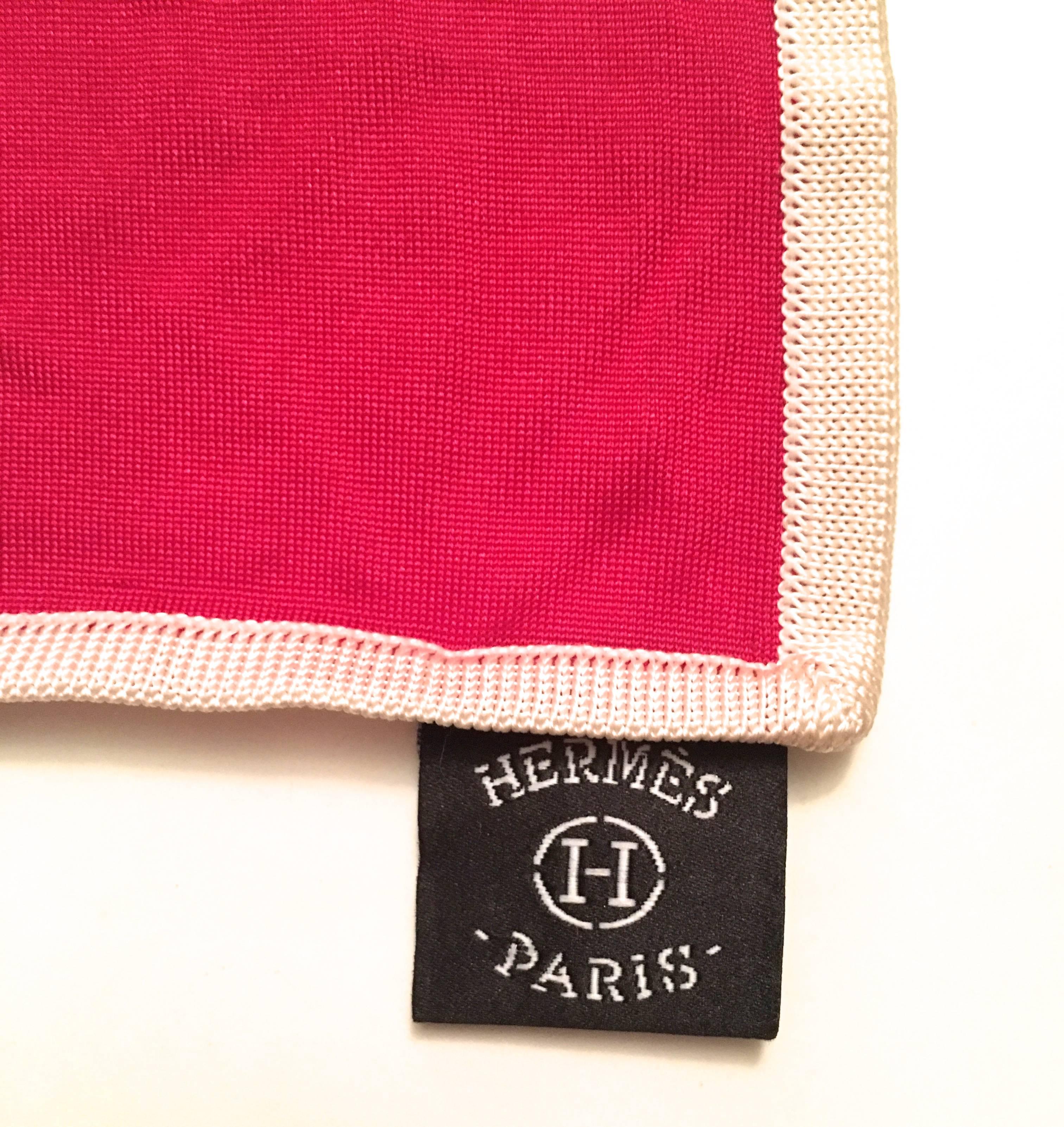 Presented here is a beautiful silk Jersey rare scarf from Hermes Paris. This magnificent scarf is made from a soft, durable silk jersey fabric. The design is comprised of a raspberry red background with striping in varying directions across the