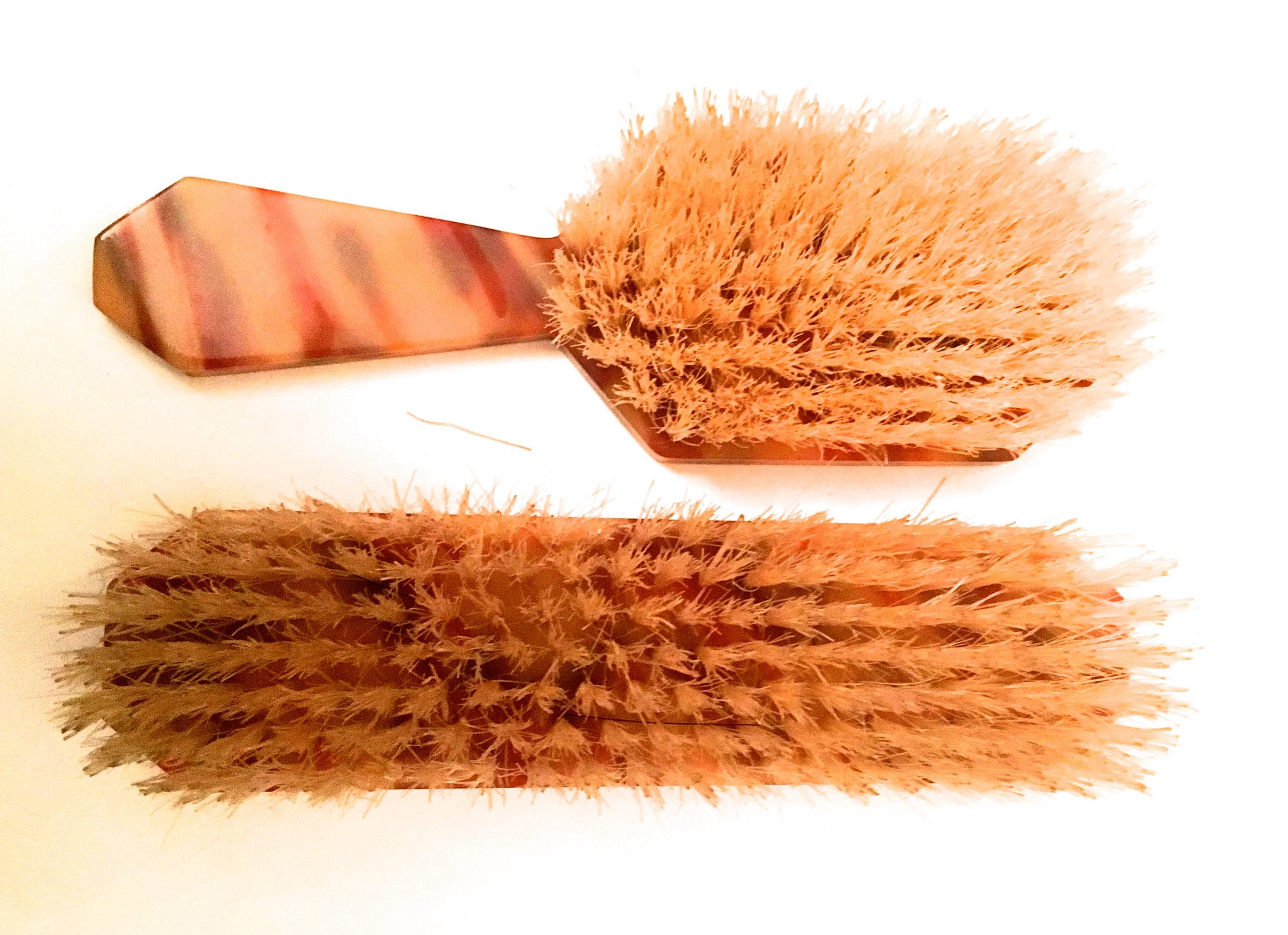 Presented here is a set of vanity hair brushes from the 1940's. This beautiful set of vanity brushes is made from bakelite. This particular color combination of bakelite is quite unusual and extremely rare. The pair of brushes are in excellent