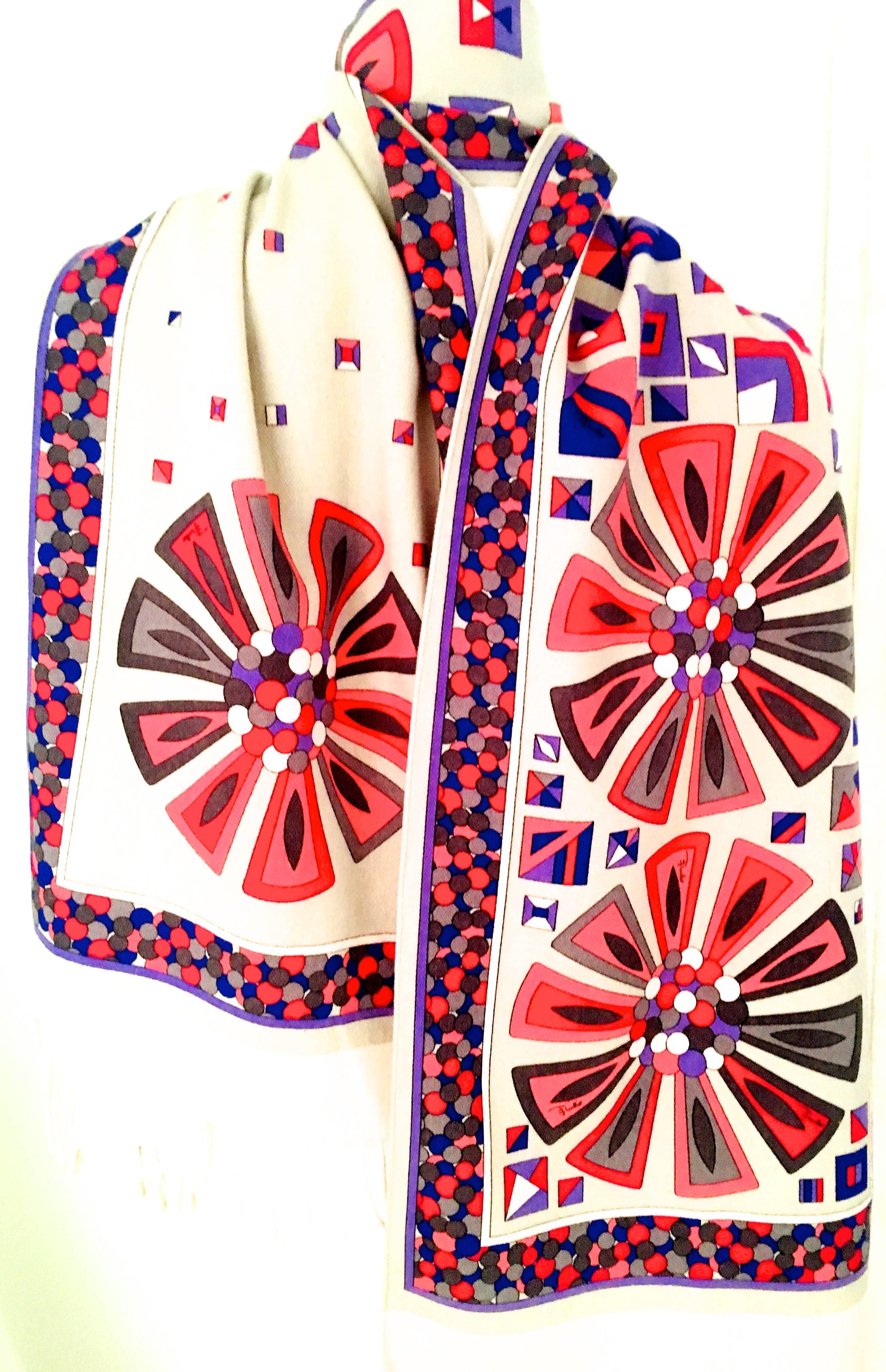 Presented here is a beautiful scarf from Emilio Pucci. This rare scarf is made from a blend of 60% wool, 35% cashmere and 5% silk. The design is a series of shapes arranged in circular patterns in the center. There is a border around the perimeter