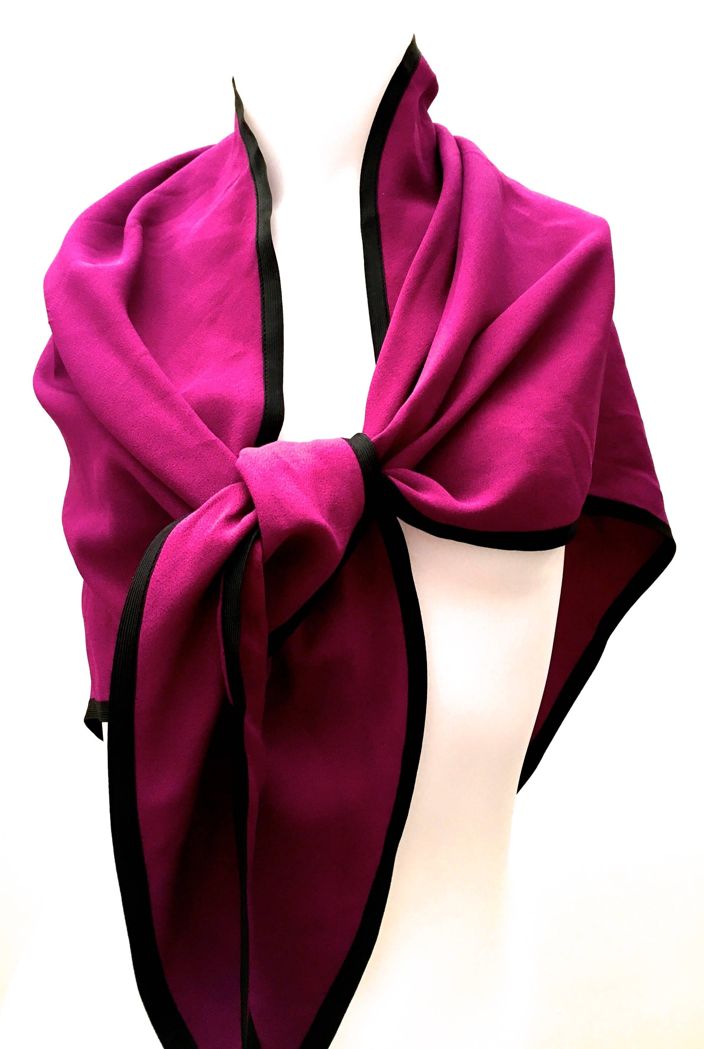 Presented here is magnificent Saint Laurent Rive Gauche shawl in beautiful shade of magenta. There is a 1/2 inch black flat silk ribbon trim around the perimeter of the shawl. The border highlights the rich coloring of the rest of the scarf. This