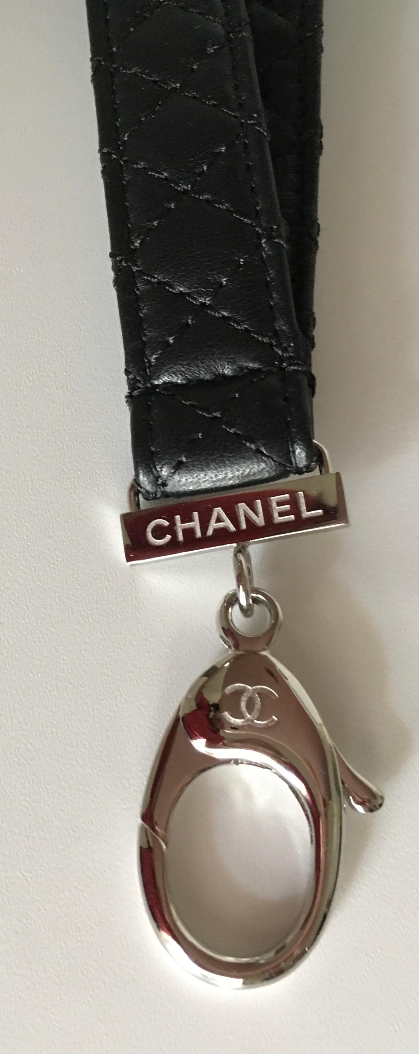 Presented here is a beautiful new Chanel Lariat. It is available in silver tone or gold tone.
the 3/4 inches wide leather necklace part measures 30 inches long. The clip on piece attached measures  another 2 inches.