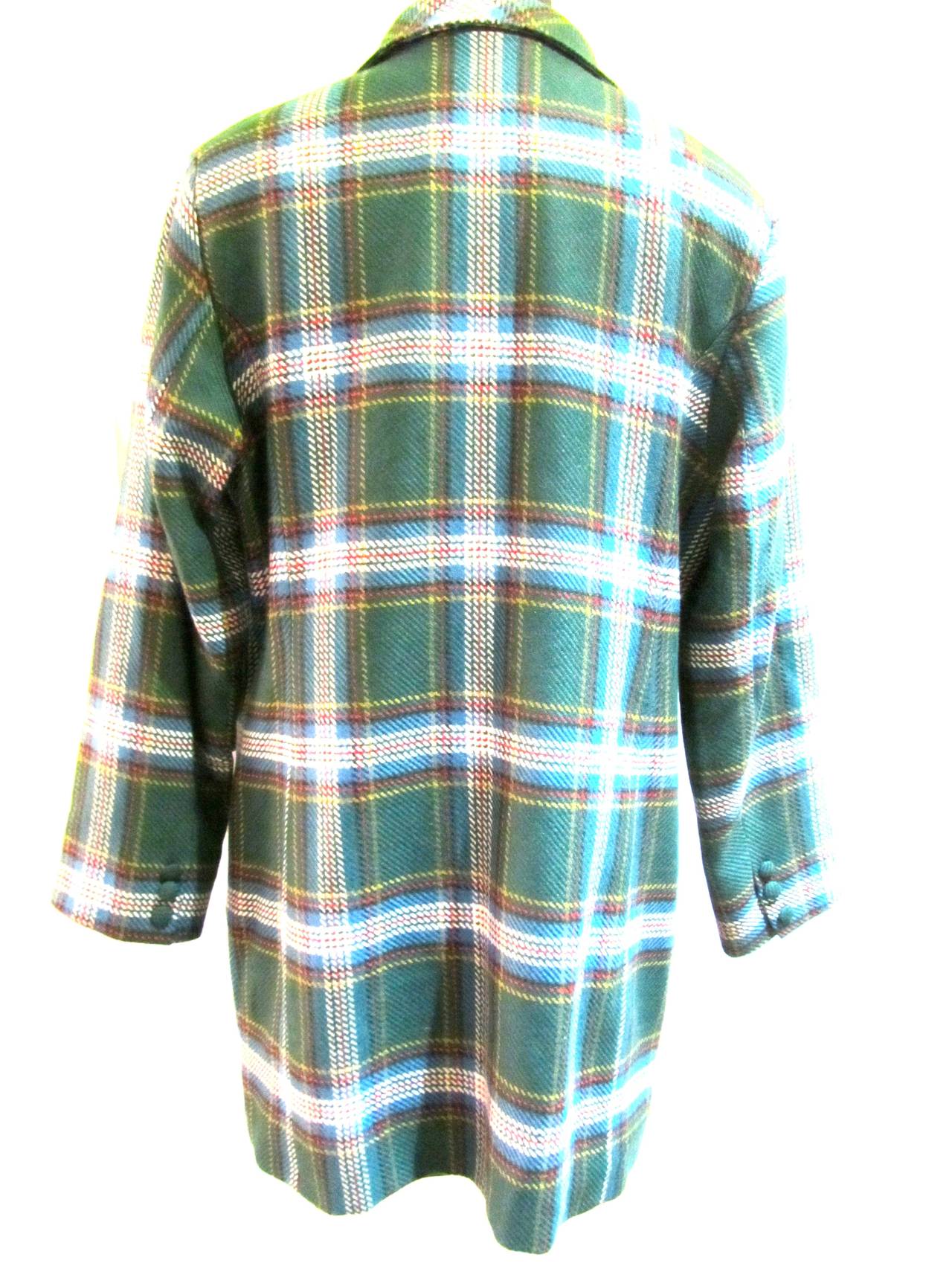 This plaid jacket presents itself in mint condition of beautiful colors green, yellow, blue, black, red, and white. Beautiful buttons on each sleeve. Double breasted. 6 buttons on front with extra button inside lining. As current today as it was