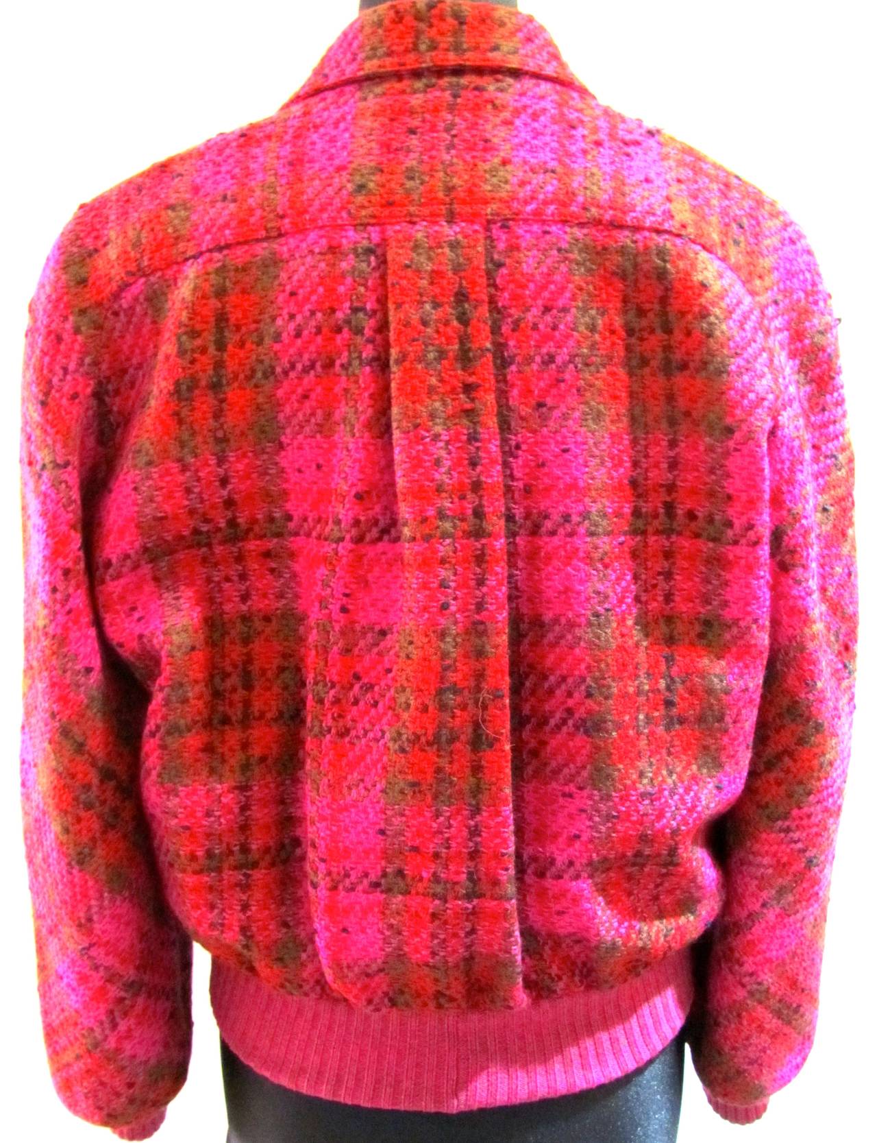 Valentino, Miss V. Boucle wool double breasted bomber jacket. Plaid fabric has colors of fuchsia, red, green, and black. Size 40. 1980's. 

Remarkable piece that is in excellent condition.