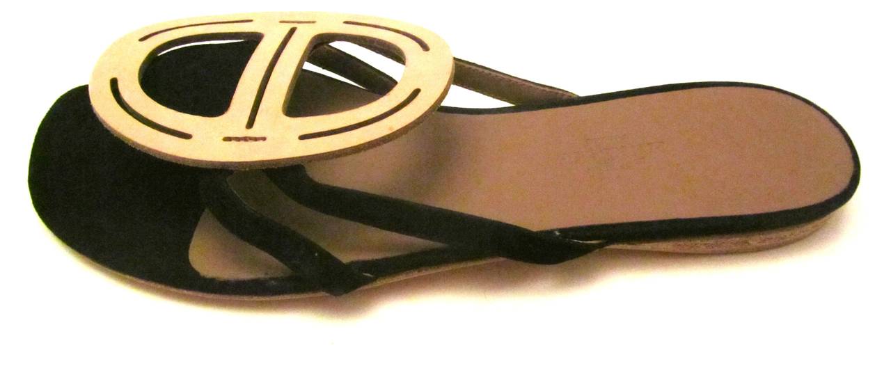 New Hermes black suede leather flip flop sandals in size 36. Beautifully designed sandals that have a soft black suede throughout with classic beige with iconic Hermes design on strap.