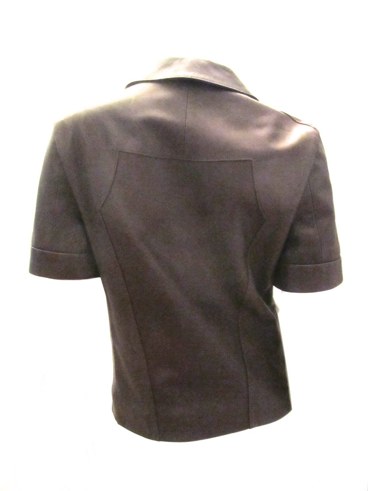 This brand new Narciso Rodriguez brown short sleeve leather jacket retails for ove r$2000.00. The incredible butter soft leather has front zip closure.  The Jacket can be worn for either formal or informal occasions and in a variety of settings.