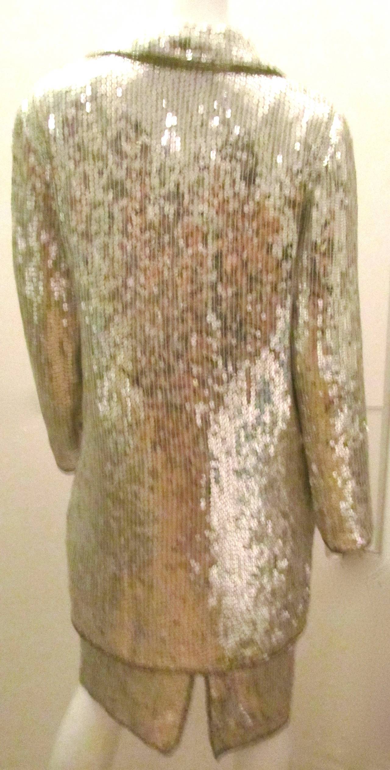 Hello Studio 54. This two piece silver sequin jacket and dress is a perfect example of the 1980's disco era. Sterling silver sequin dress looks magnificent on its own and even more fabulous with the matching colored jacket with two front pockets.