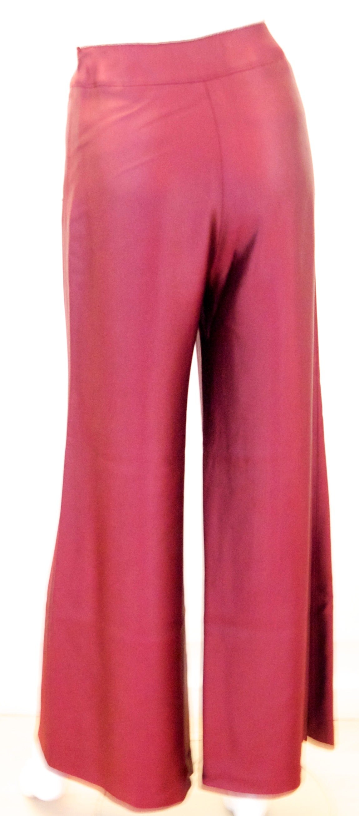 Chanel burgundy cocktail pants. Size 34. This beautiful pair of burgundy Chanel pants are perfect for a cocktail party. The fabric is a beautiful heavy silk lined feeling and flow naturally and beautifully on the body. The pants comprise a silver