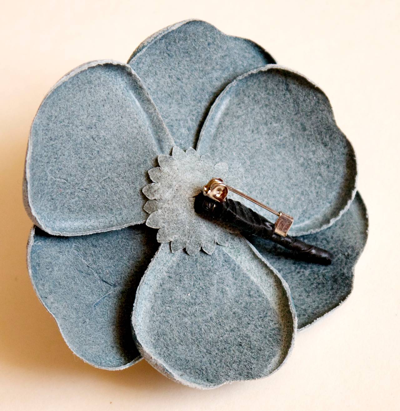 Chanel light blue camellia pin. The pin is a light blue leather that is distressed on the outer edges creating a lighter shade of blue on the outer rims of the petals. The pin is missing its tag on the back of the pin. Gorgeous pin that is