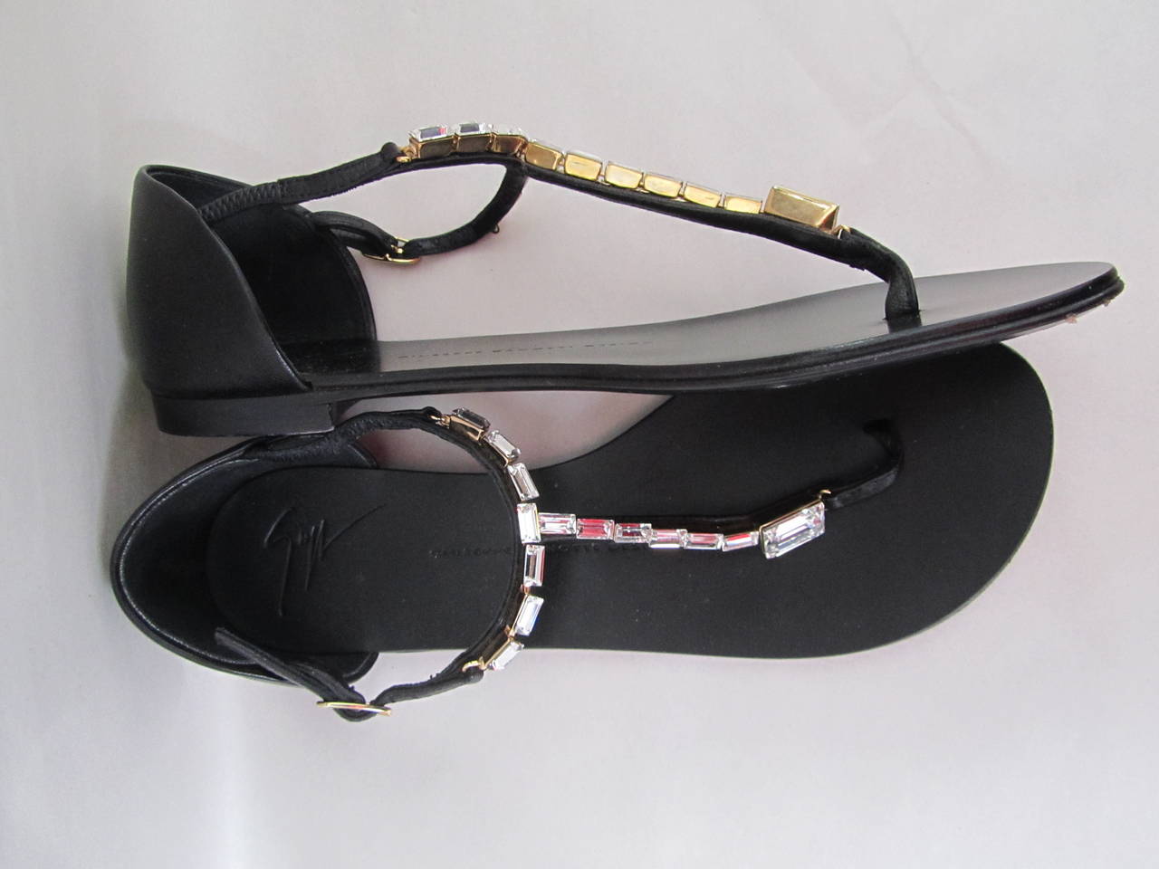 Giuseppe Zanotti strap sandals. Black sandals encrusted with gorgeous rhinestones. Remarkable sandals that are good for both informal and formal occasions. Slight wear on the bottom from a couple of fittings, but otherwise excellent condition.