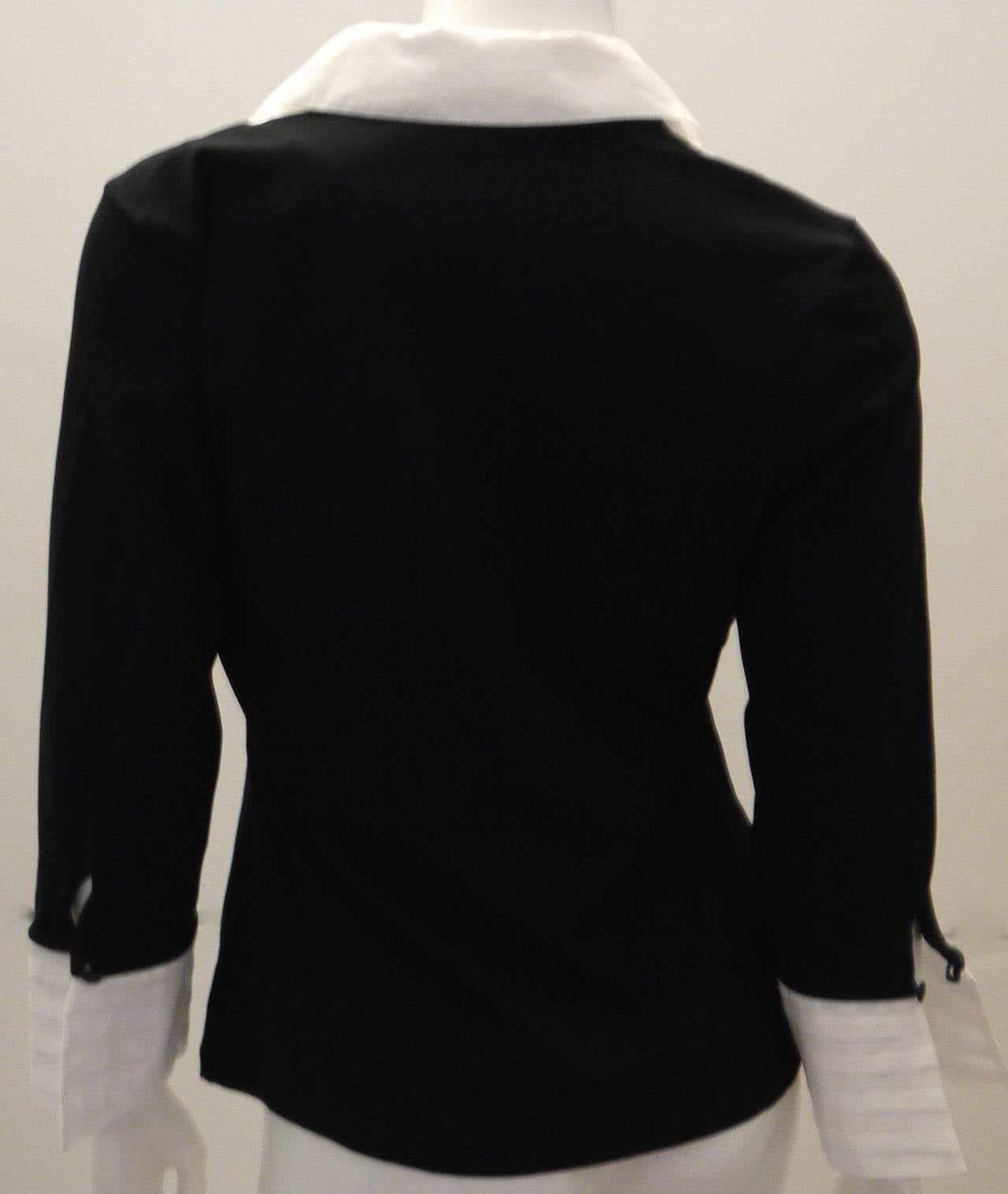 New Anne Fontaine blouse that is made of 93% cotton and 7% elastic in the body of the shirt. The white cuffs and collar are 100% cotton. Size 40. Beautiful top that is great for both formal and informal occasions. Beautifully crafted top.