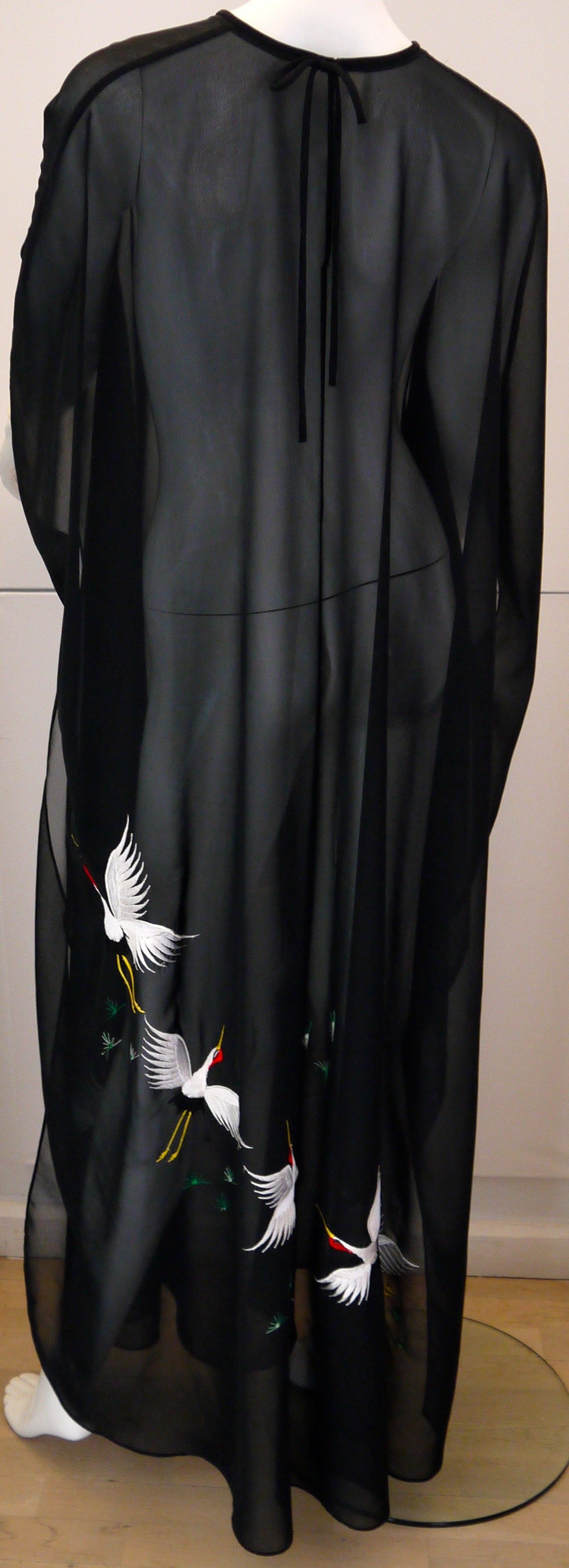 Presented here is a very unique and interesting piece from the 1970’s. It is a large size caftan which is a sheer black. It is meant to be worn over a bathing suit or other items of clothing due to the fact that it is see-through. It has a single