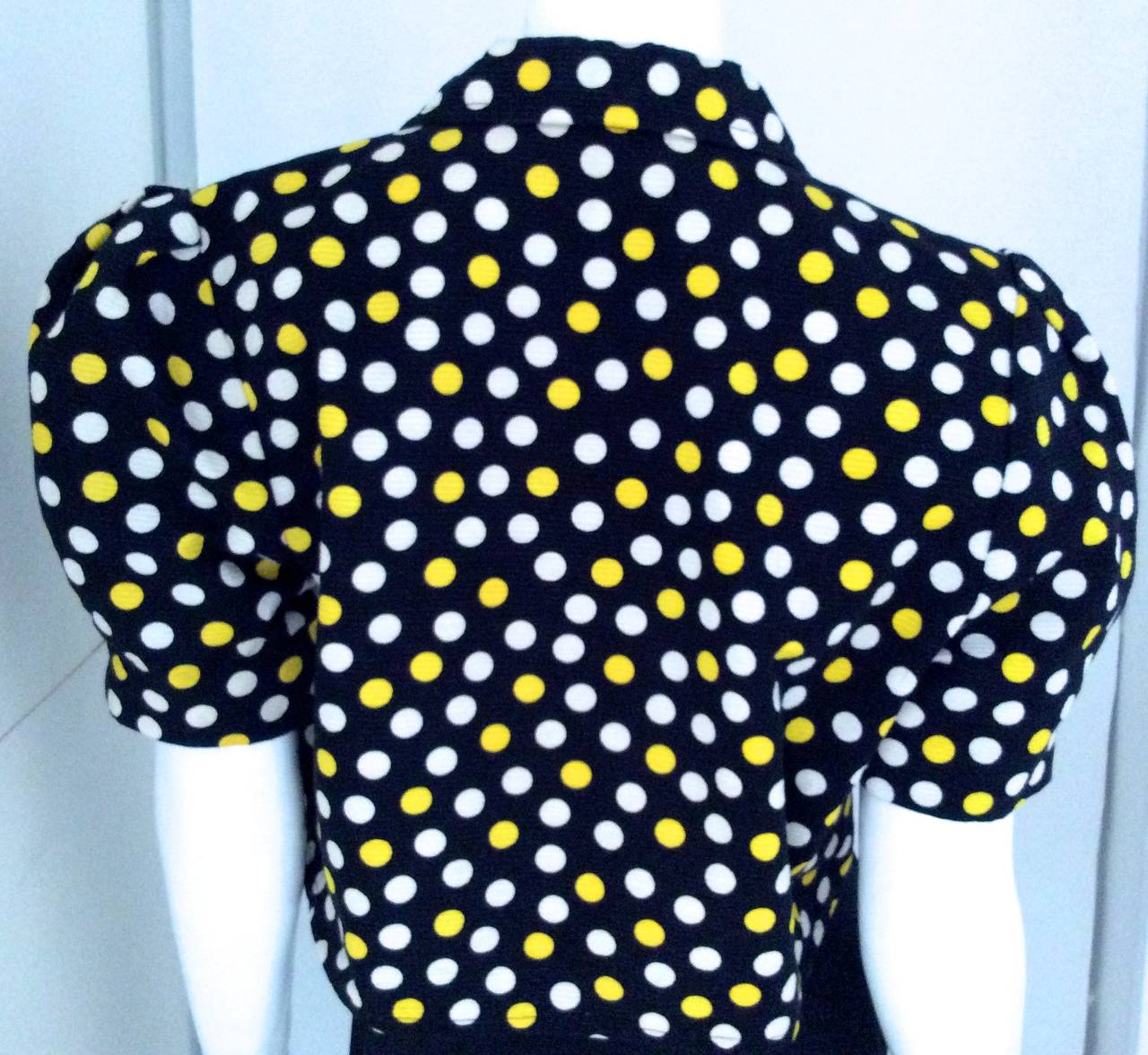 1980's cotton polka dot bolero. Gorgeous St. Laurent style bolero. Excellent condition. Dark navy blue bolero with white and yellow polka dots. 

Total length - 18 inches
Shoulder to shoulder not including puppy sleeve 15 inches
Shoulder to