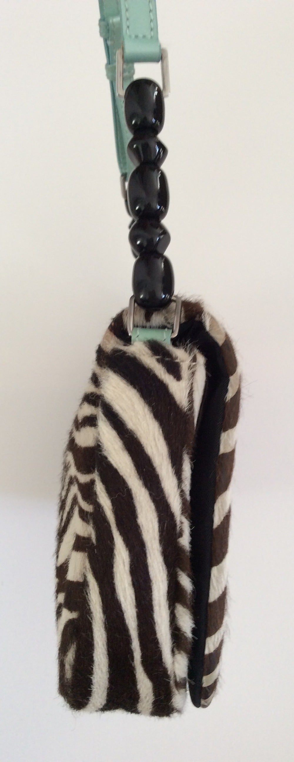 This Christian Dior extremely rare 3 piece set consists of a beautiful brown and zebra print pony fur purse which comes with a matching wallet and matching cross body cell phone bag. All are in good condition and show minor signs of use and wear.