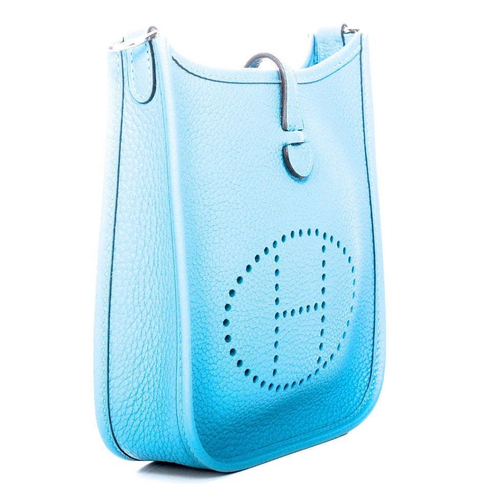 New mini Evelyne / Evelyn in original box. Gorgeous mini Evelyne in turquoise blue with amazone strap. Great cross body bag that is perfect for all basic necessities. The leather on the bag is Clemence, there is a snap on the back of the handbag for