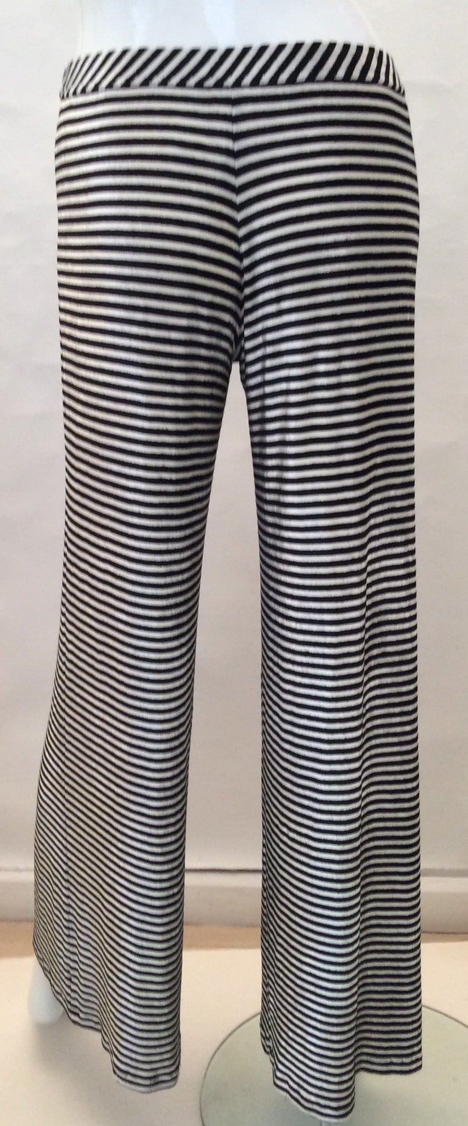 This fabulous pair of Chanel pants is believe it or not extremely flattering with horizontal stripe. The pants are a size 36, but pay attention measurements because there's a lot of give and they run a little big. The waist band has the stripe on