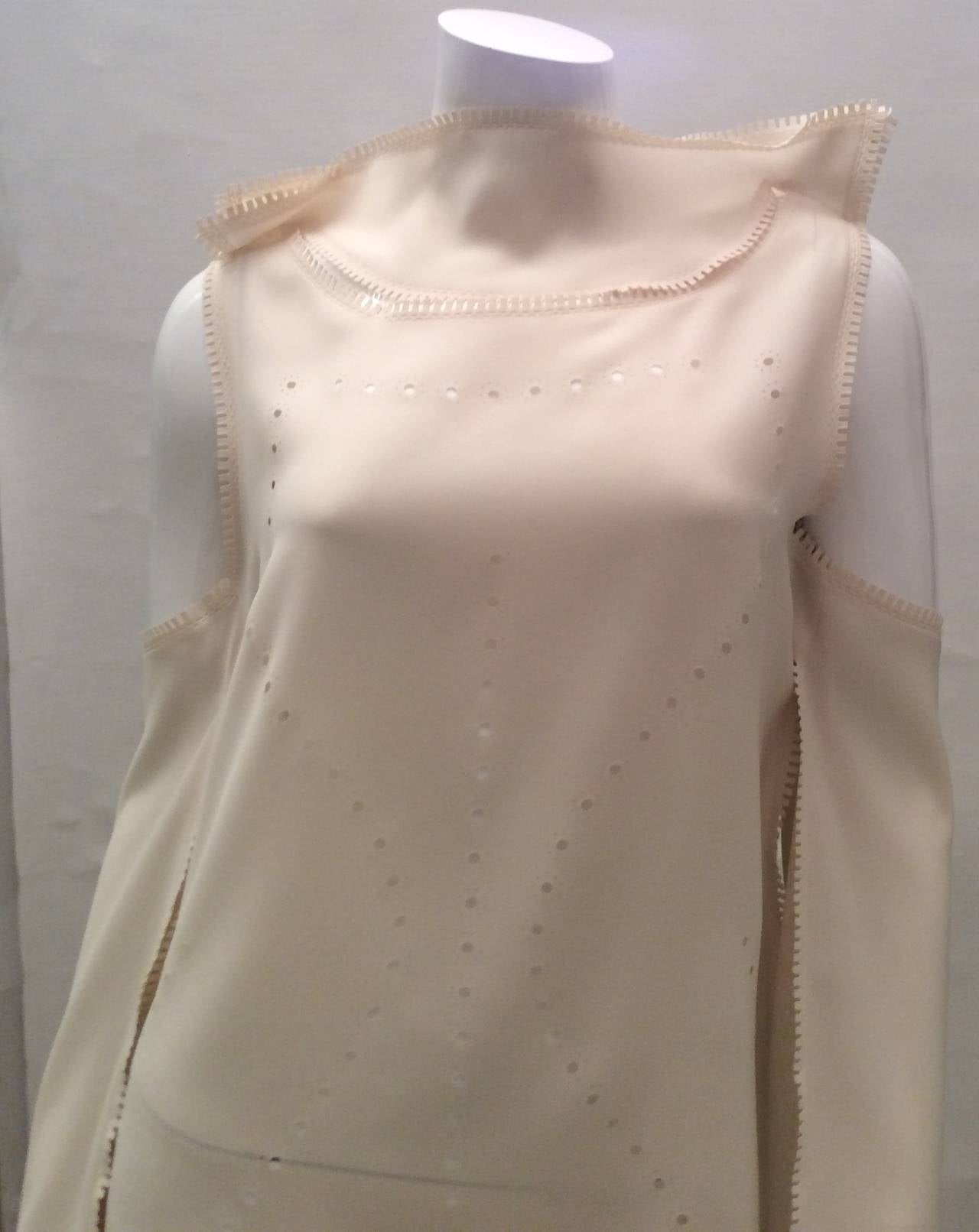 This cream silk Issey Miyake blouse is one of the most beautiful blouses I've ever seen. It has been worn once and is in pristine condition. It is difficult from the photos to see the true beauty of this top and the many different ways it can be